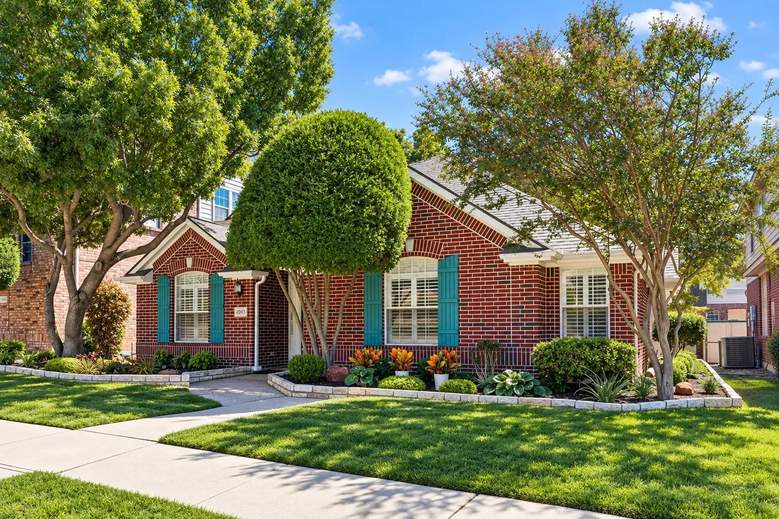 Fresh landscaping and Zoysia grass provide excellent curb appeal