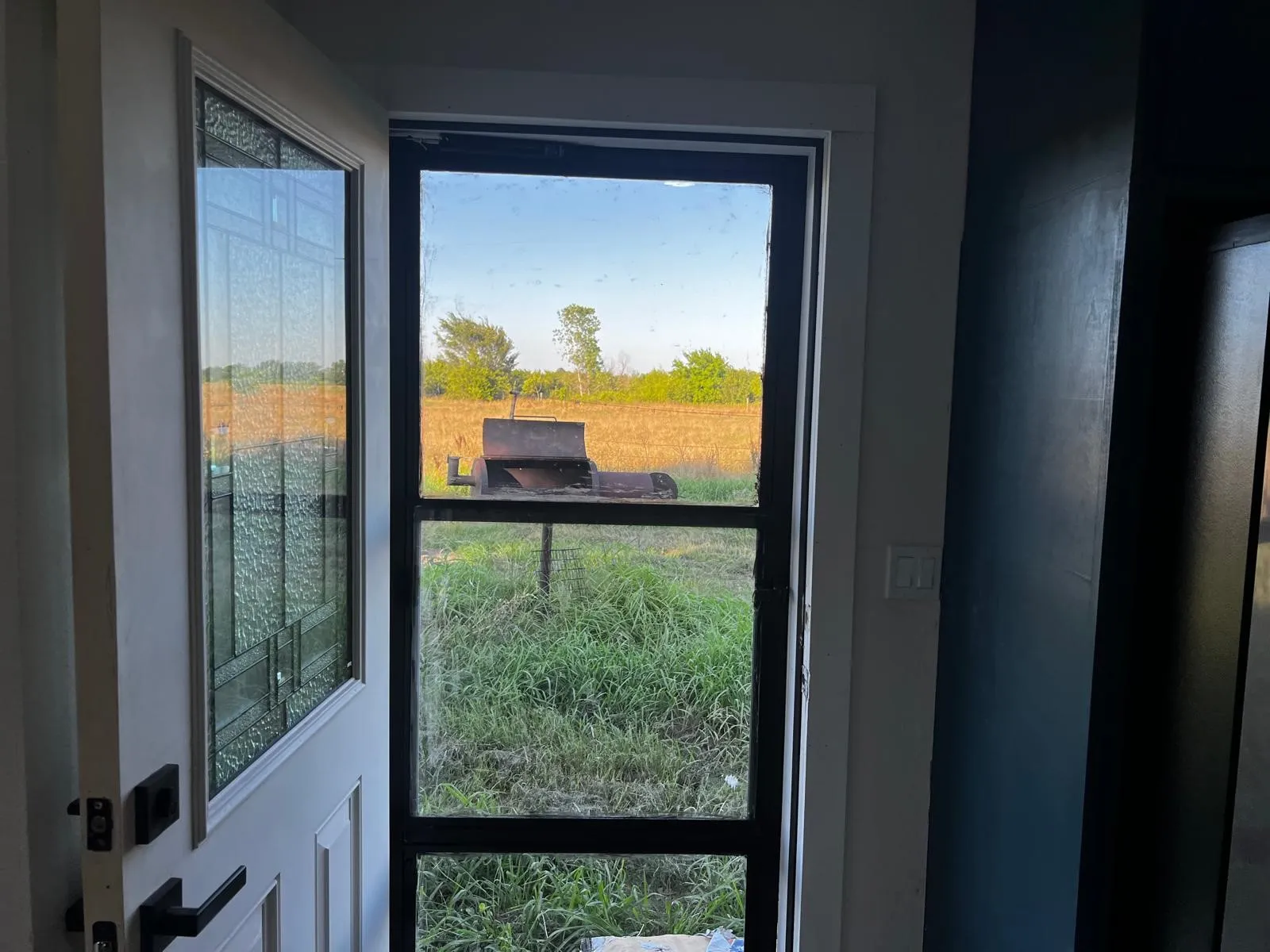 White paneled entry door with decorative glass insert