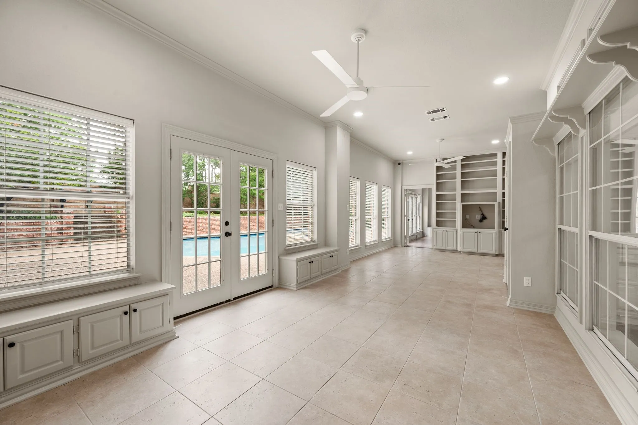 Unfurnished sunroom featuring a healthy amount of sunlight and french doors
