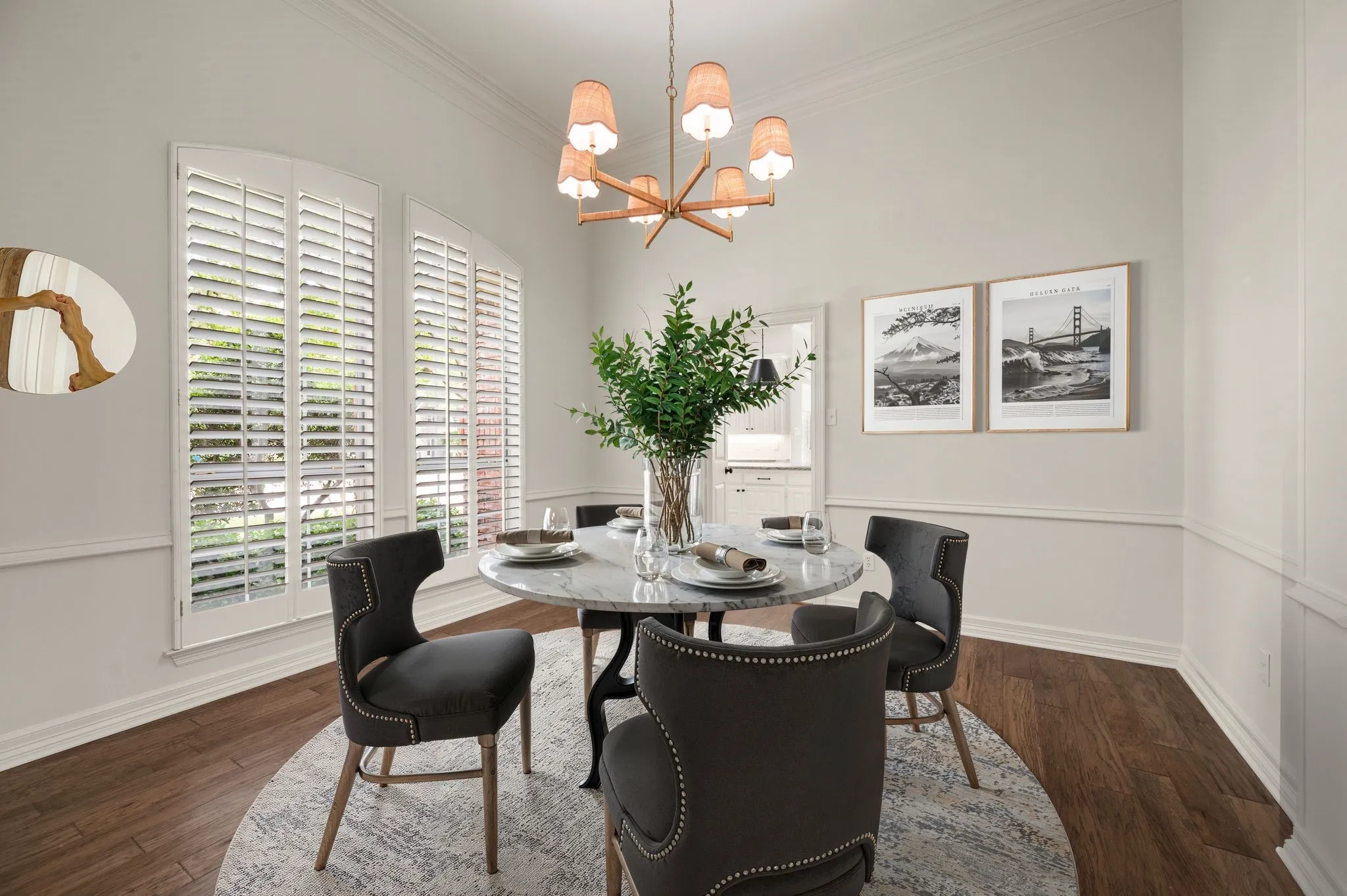 Dining space with dark wood-style floors, baseboards, a notable chandelier, and ornamental molding