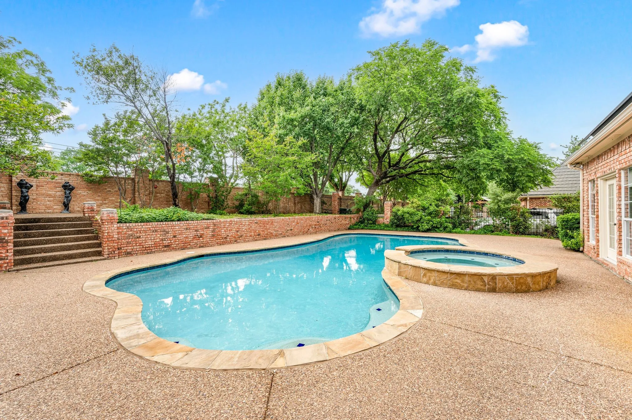 View of pool with a fenced backyard, a patio, and a pool with connected hot tub