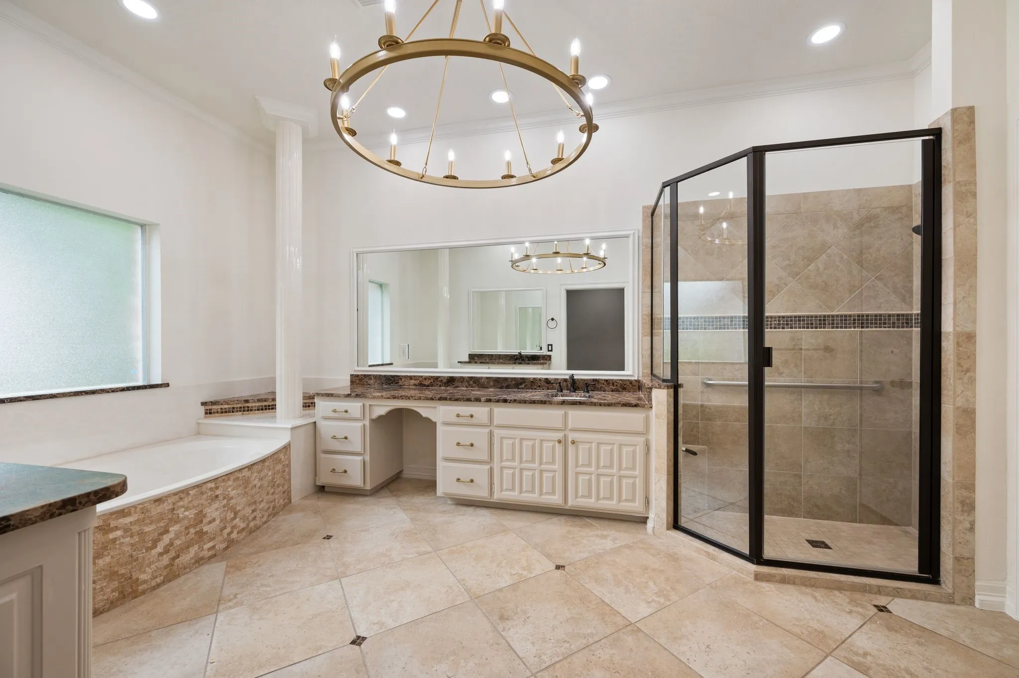 Full bathroom featuring vanity, a chandelier, ornamental molding, a garden tub, and a stall shower