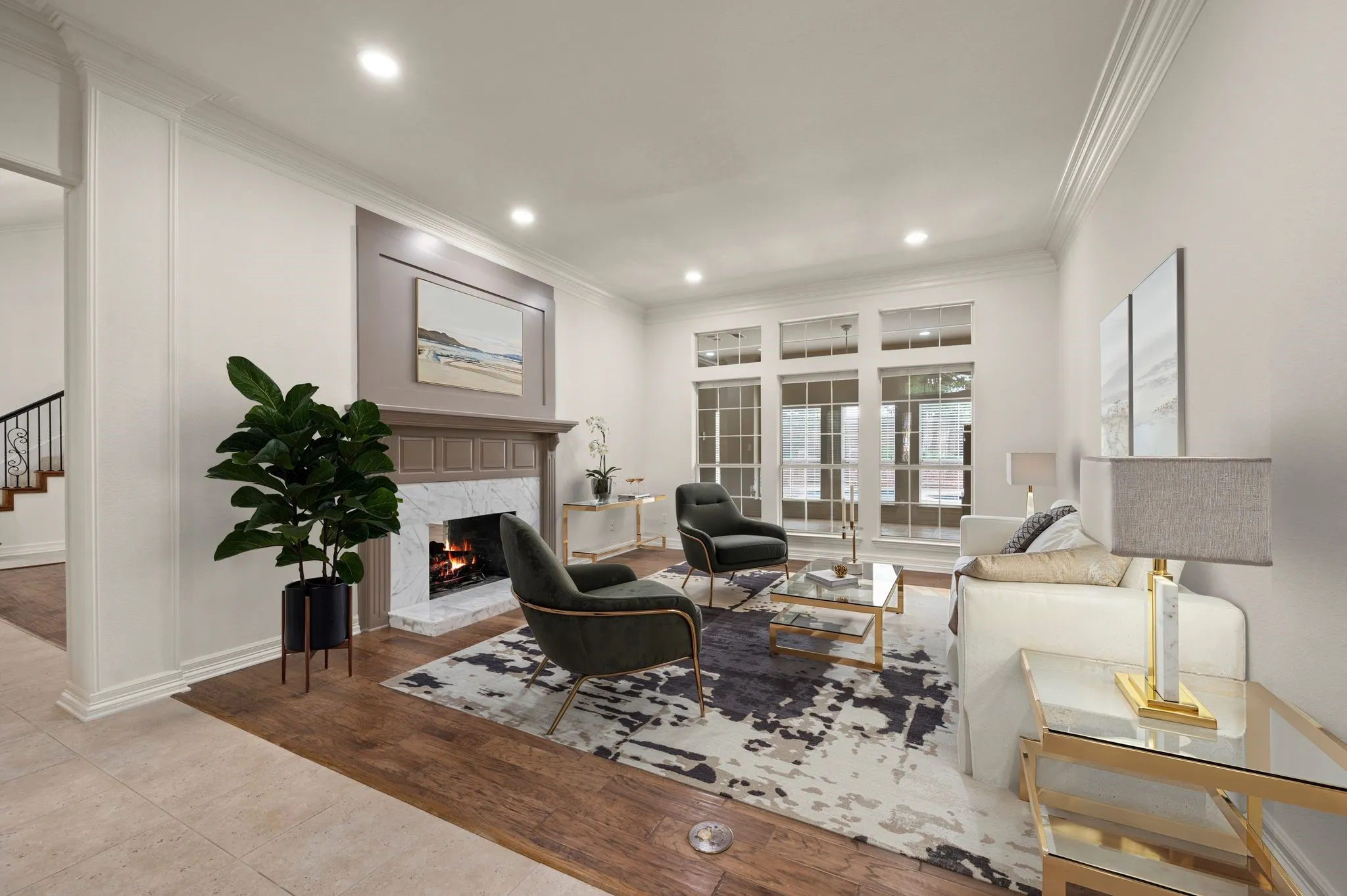 Living area featuring crown molding, stairway, a fireplace, and recessed lighting