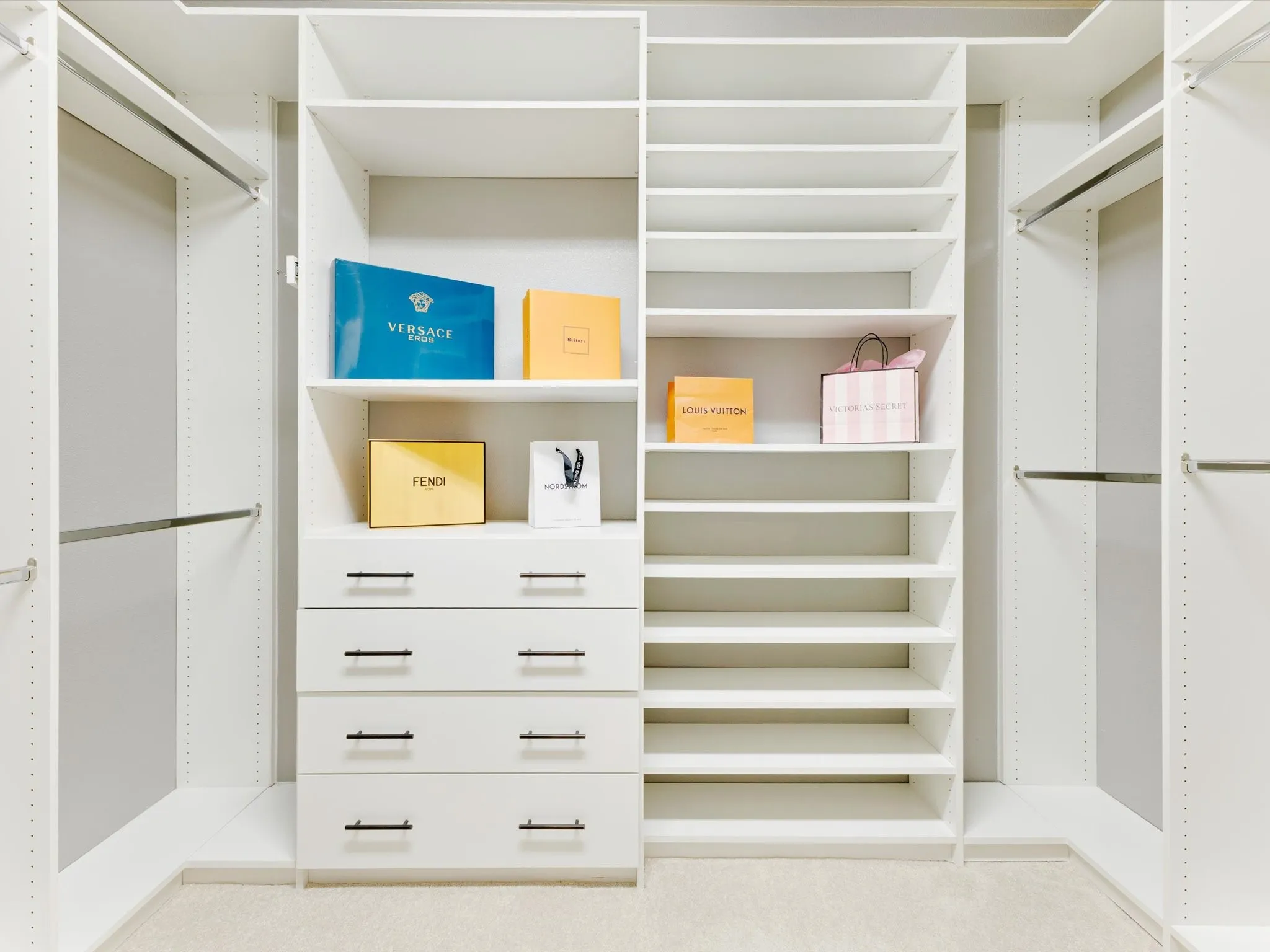 Custom closet system featuring multiple shelves, hanging rods, and built-in drawers with matte black hardware
