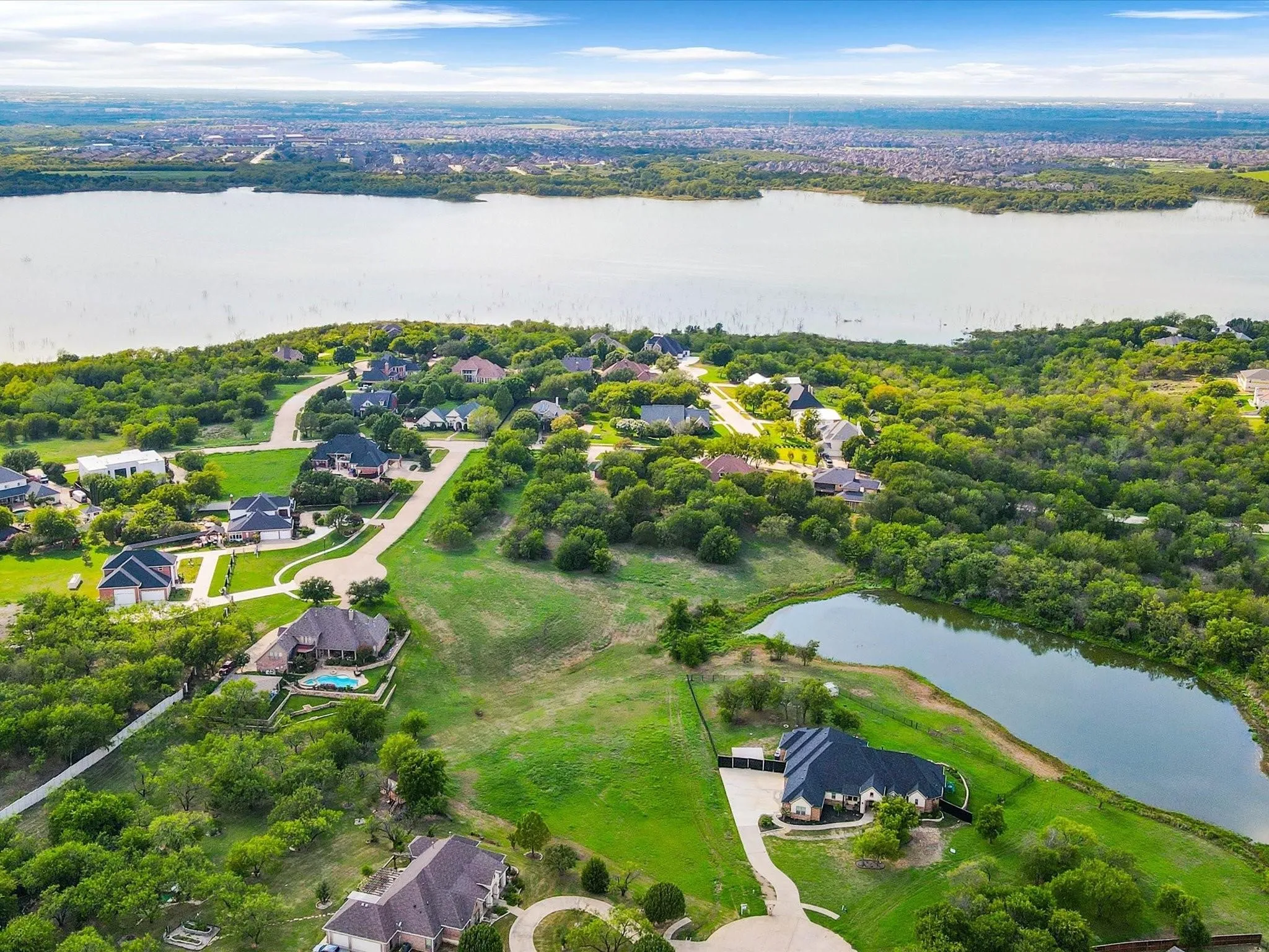 Expansive waterfront with mature trees and established residential properties