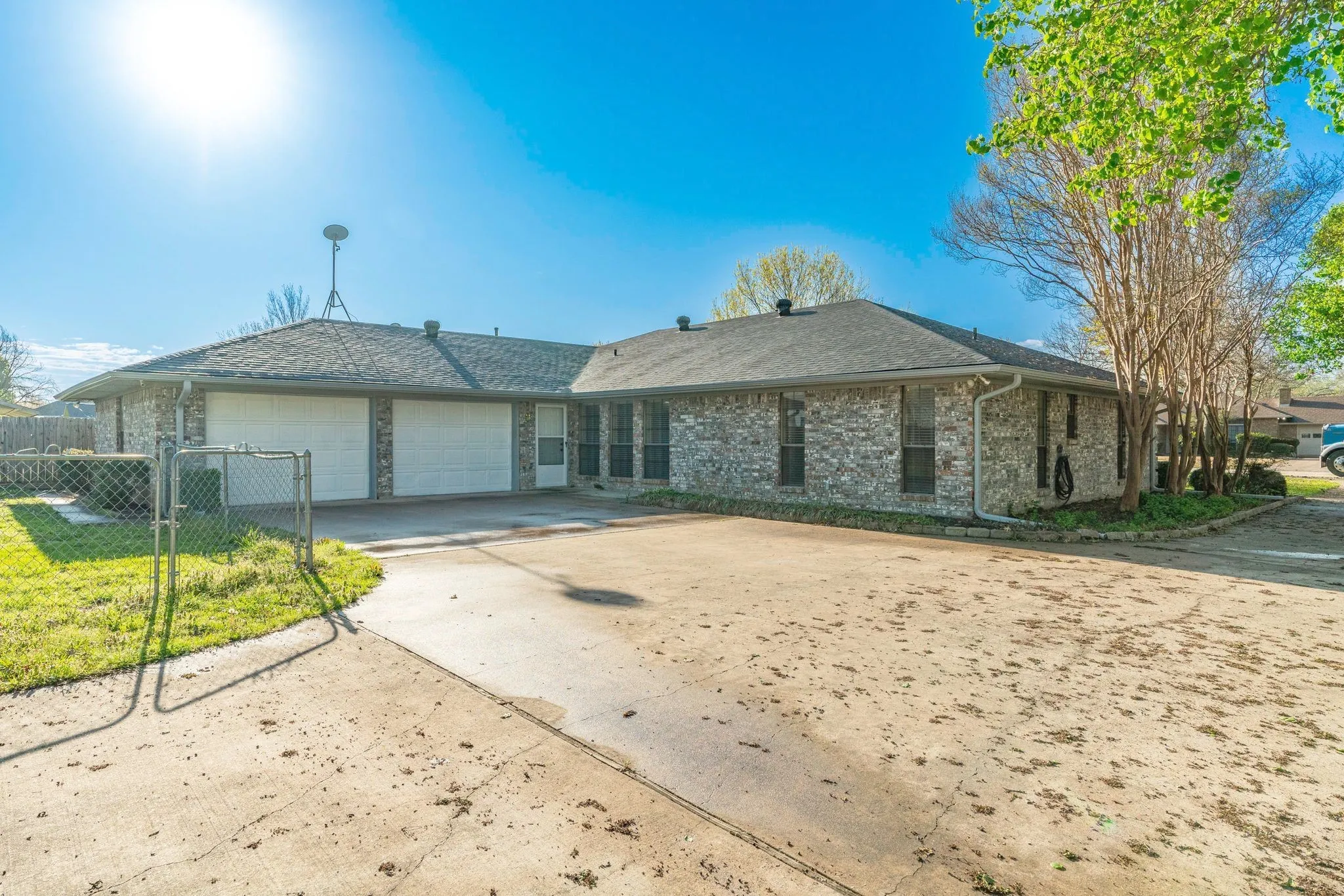 Single story home with a garage and a front lawn