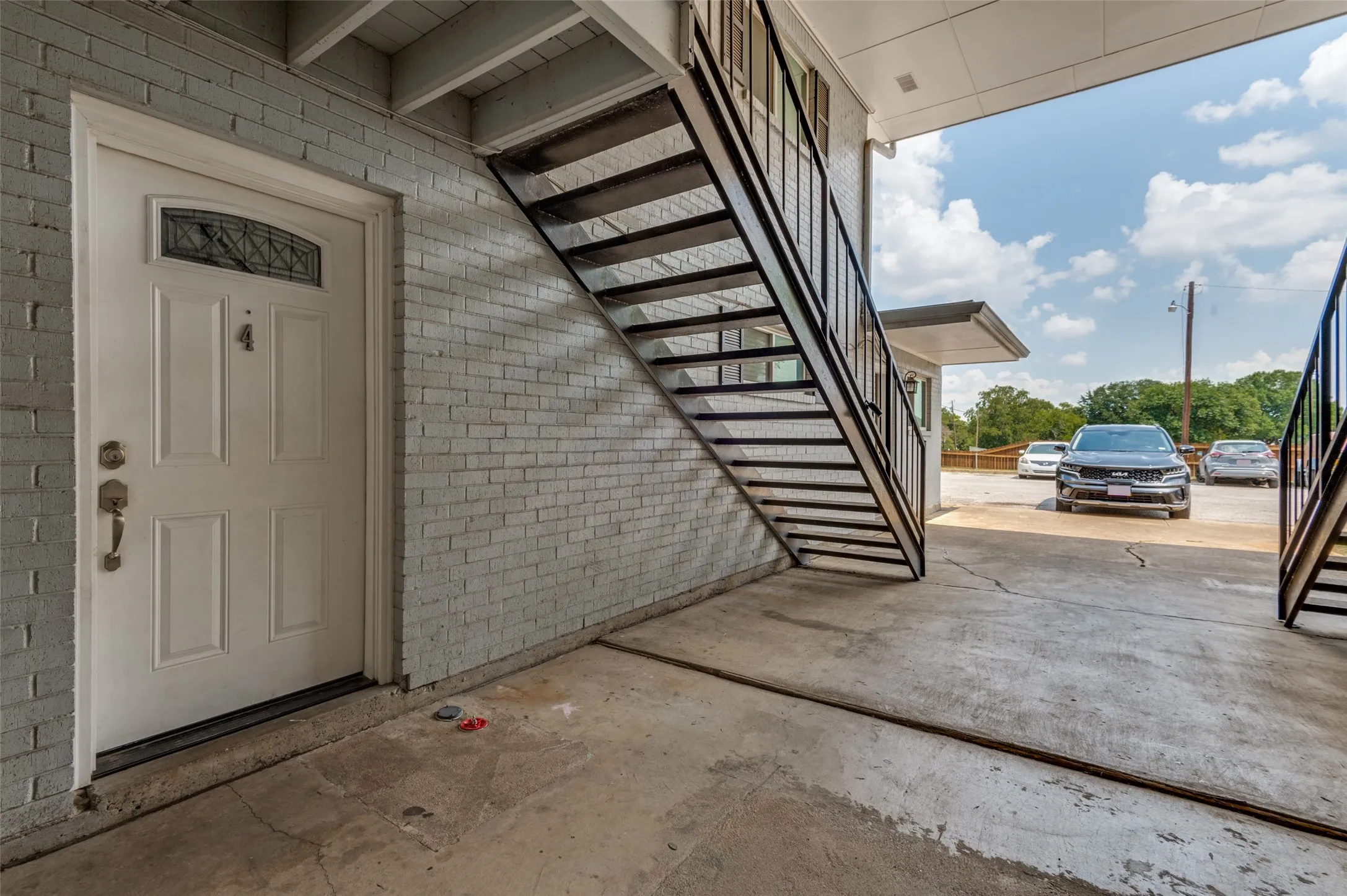 White entry door with decorative glass insert, paneled design, and classic hardware