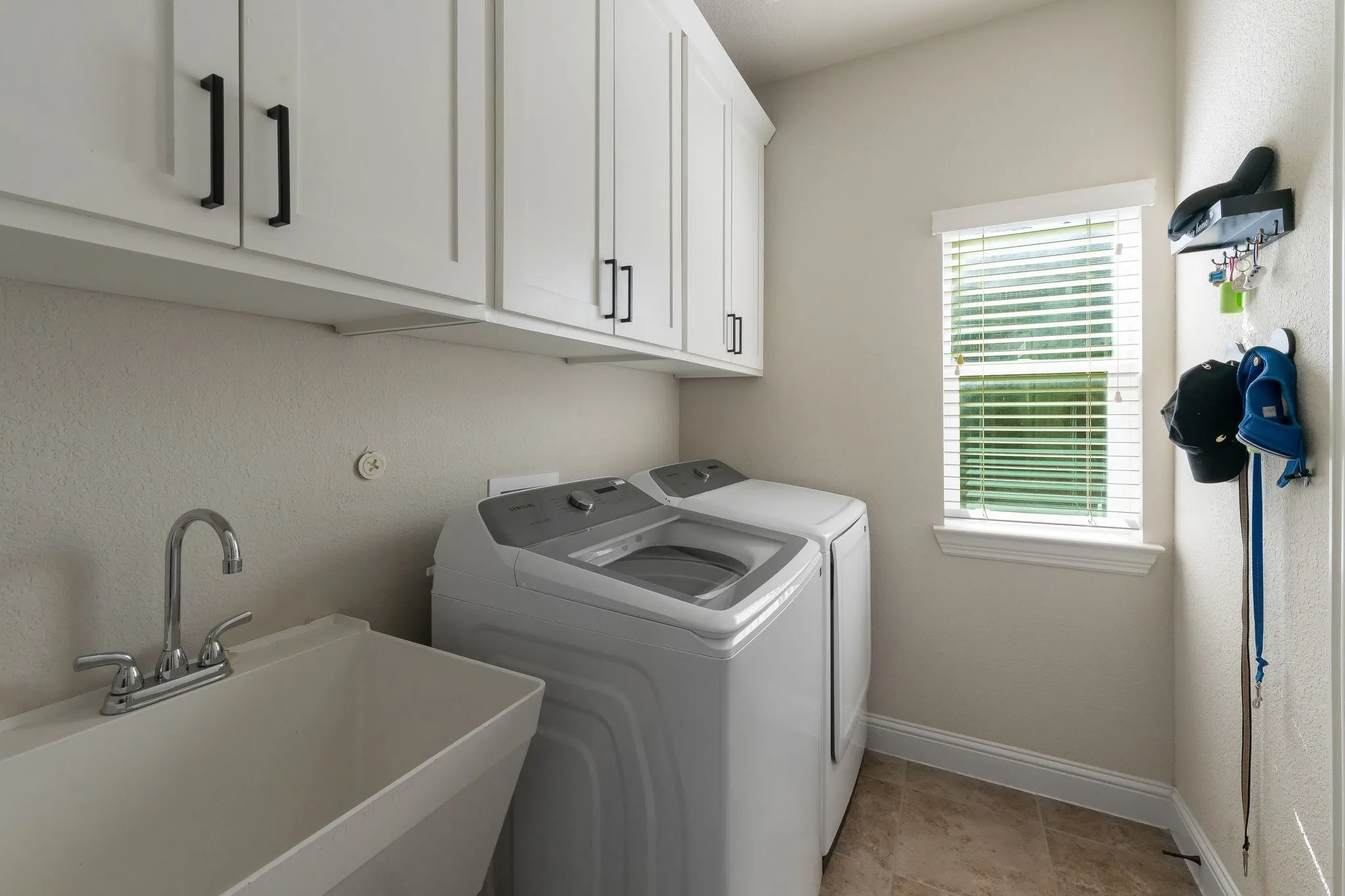 Laundry room with sink and cabinets, plenty of storage