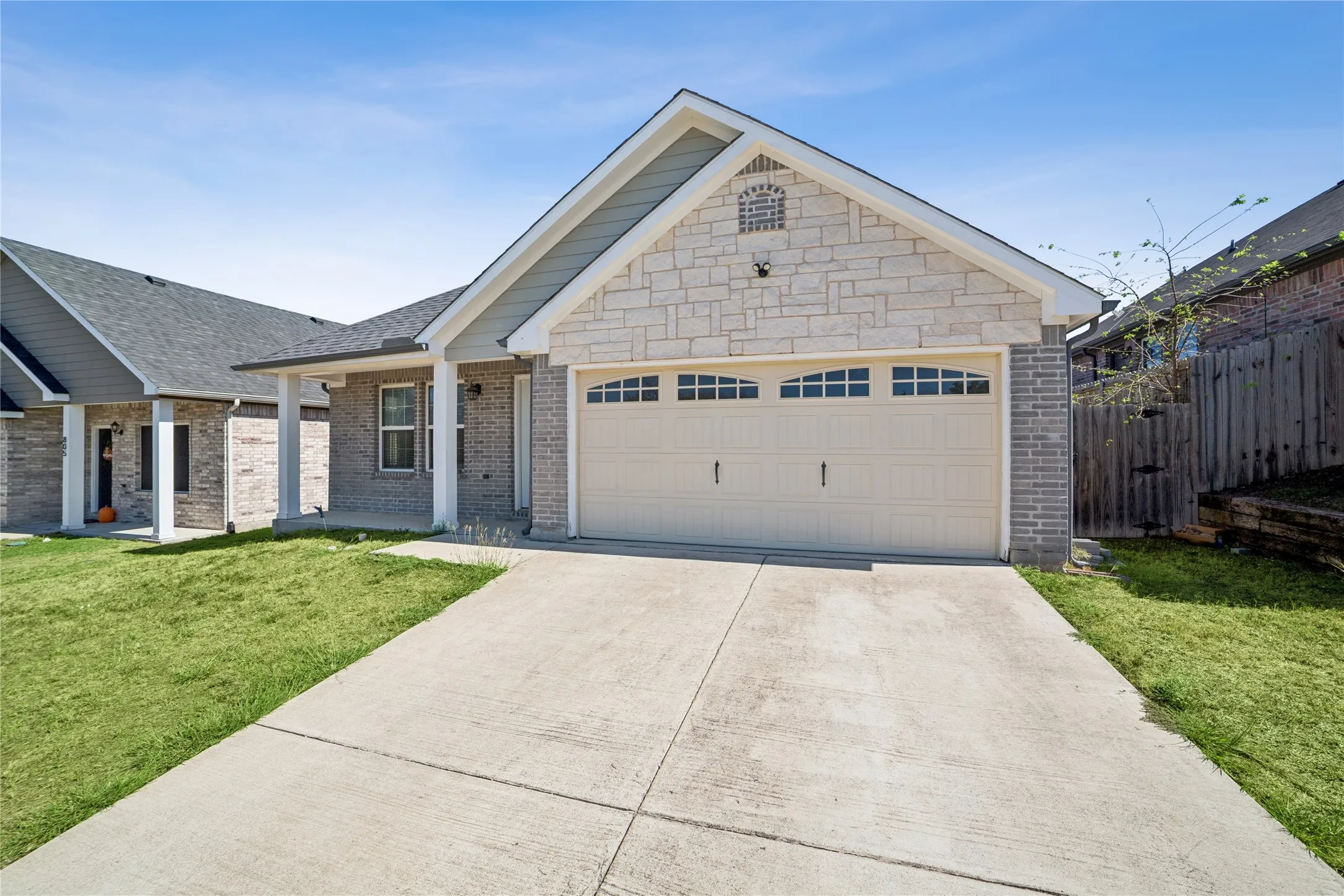 Stone and brick facade with a two-car garage
