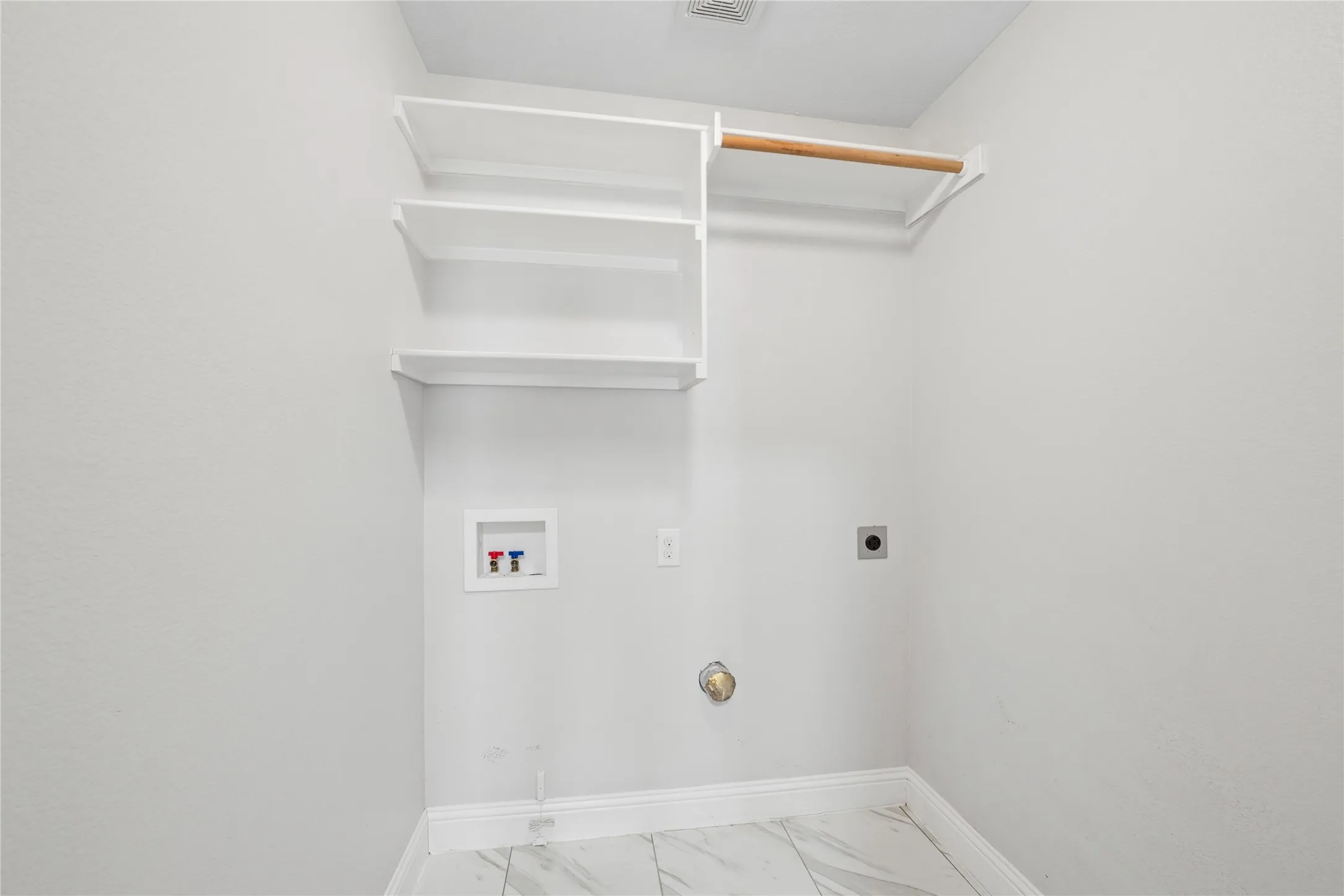 Built-in shelving, wood clothing rod, and tile flooring