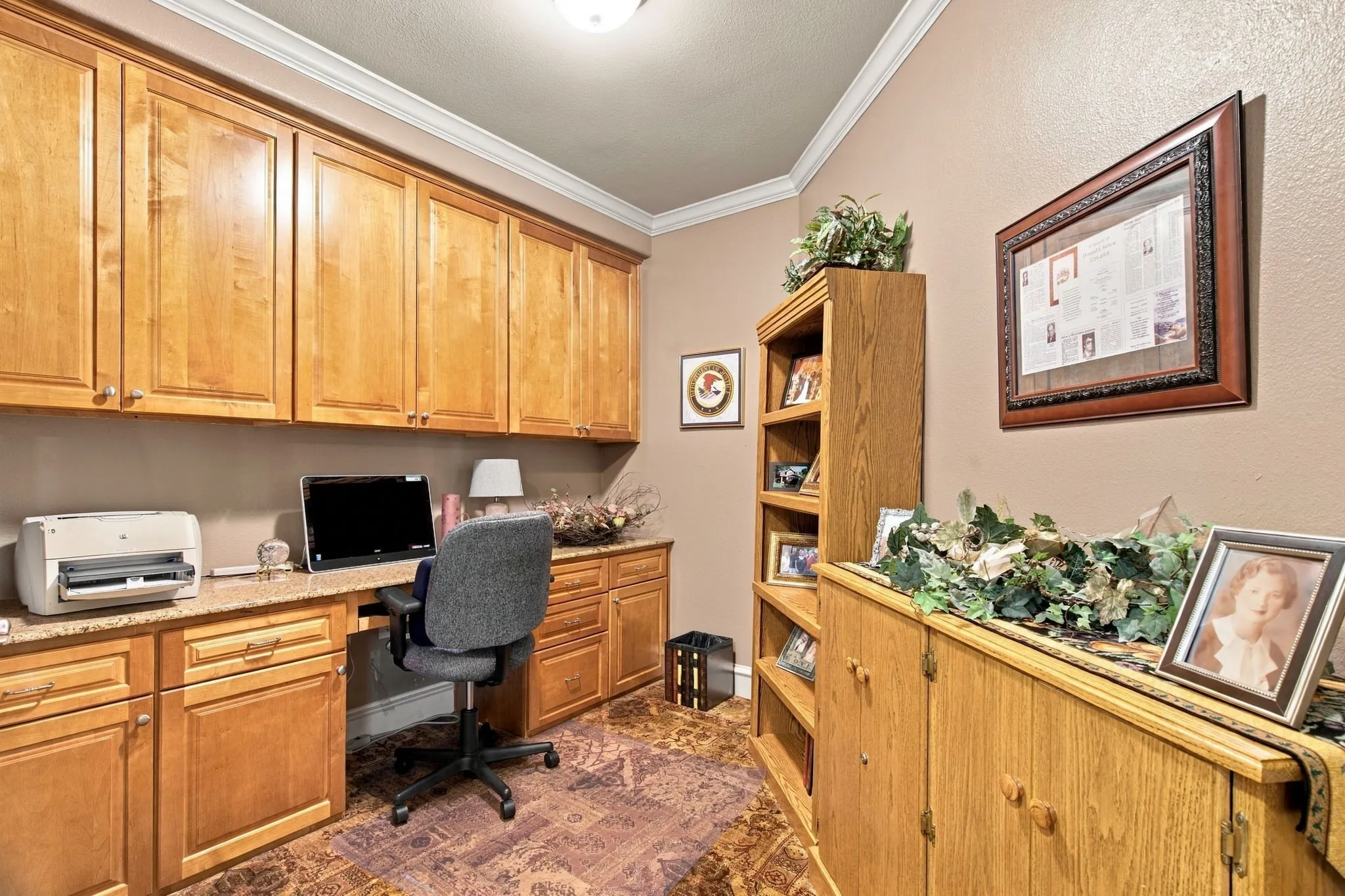 Built-in cabinetry with wood-finish doors and brass-tone hardware, providing extensive storage