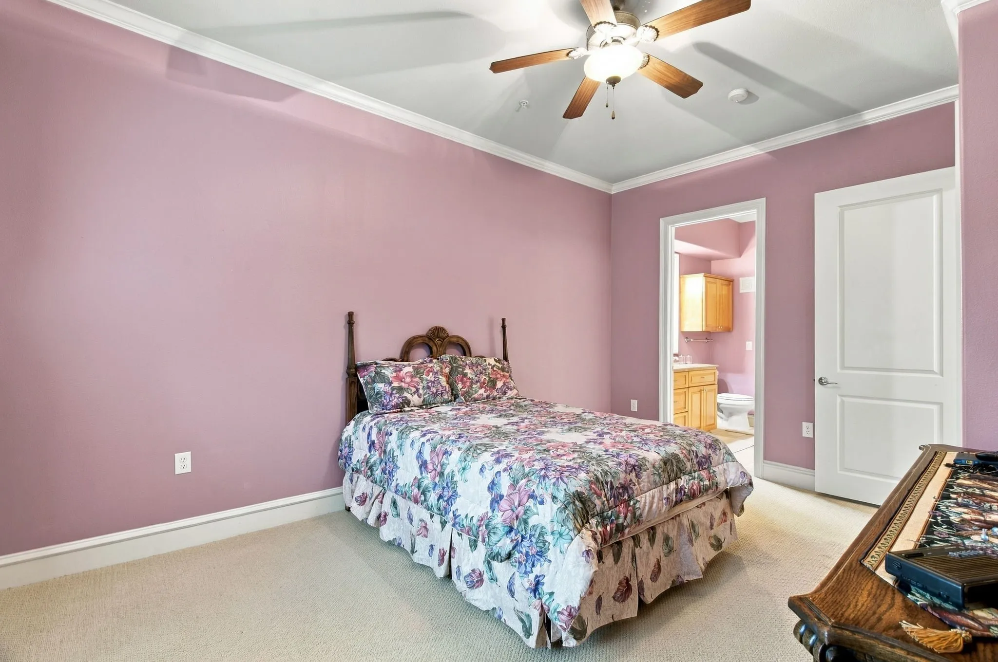 Room featuring ceiling fan, crown molding, and carpet flooring