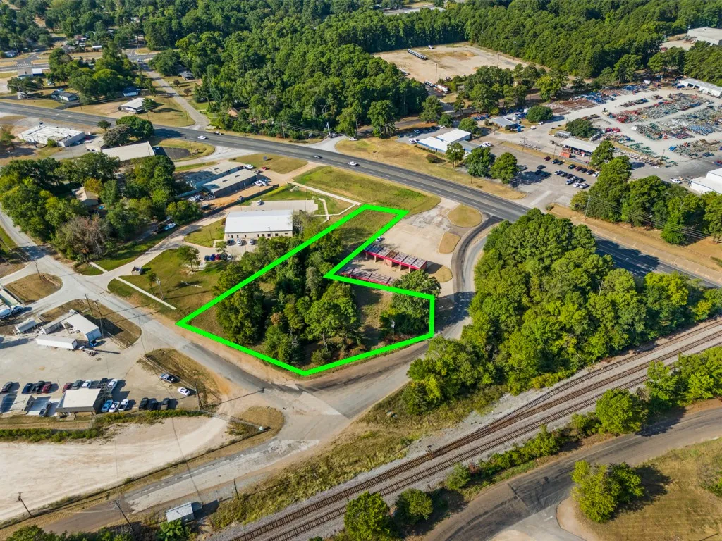 Aerial overview of a commercial parcel featuring natural tree coverage