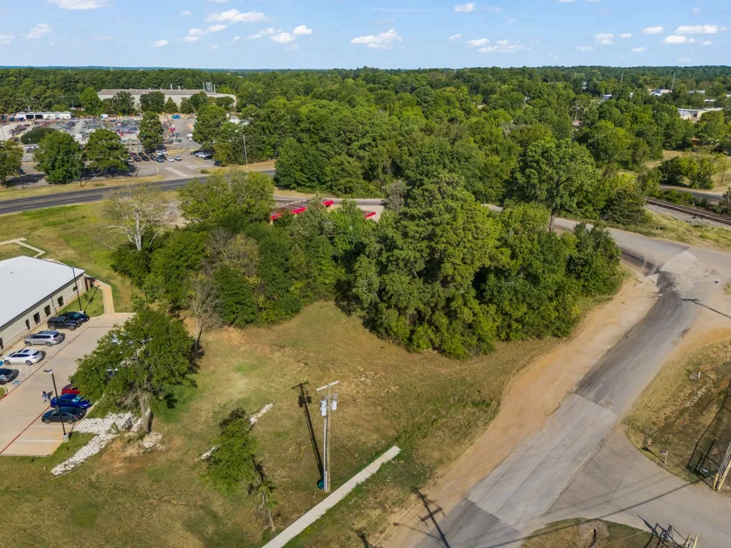 Expansive parcel featuring a verdant landscape with mature trees and direct access to paved roads