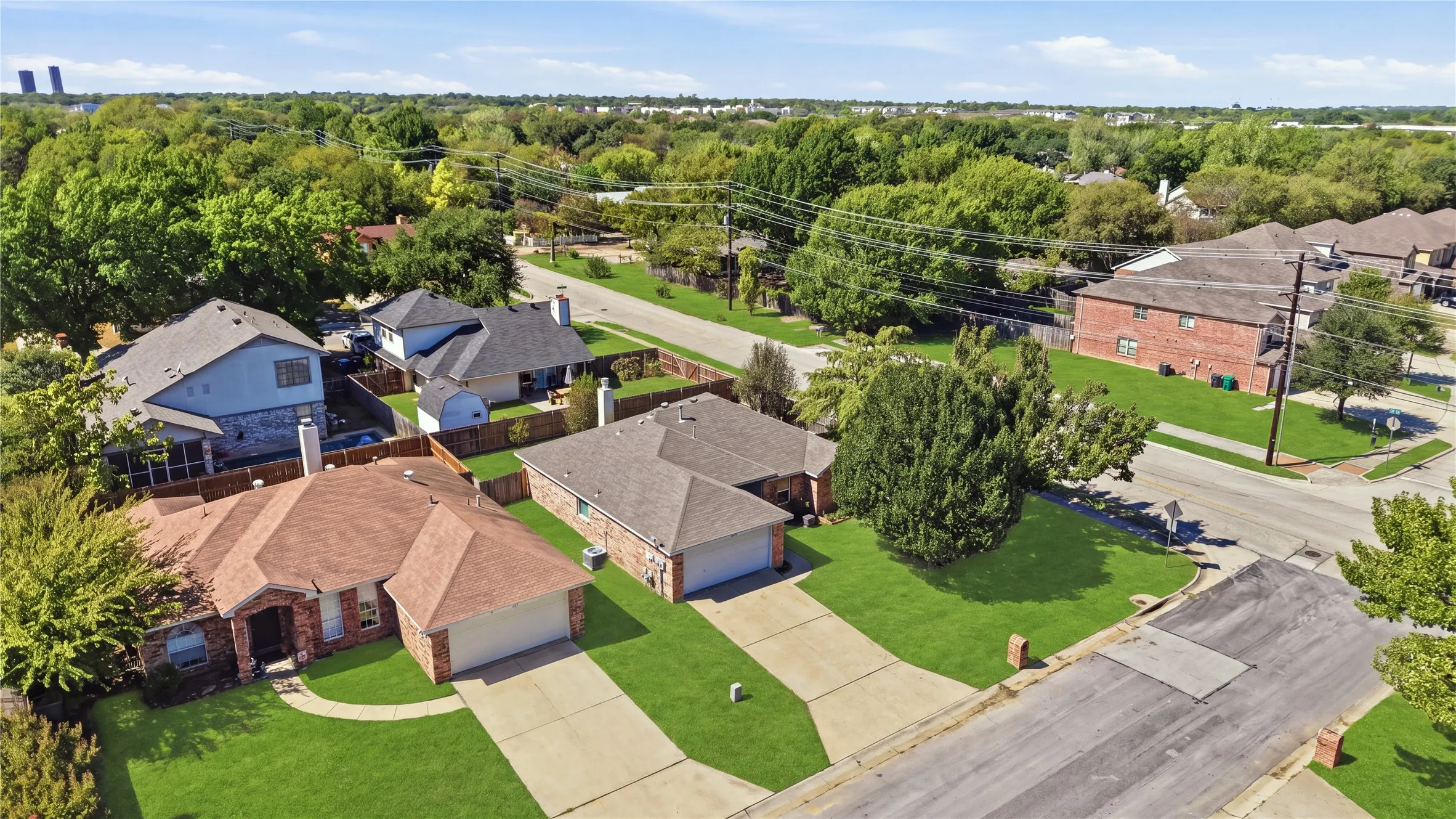 Brick exterior with an attached two-car garage, concrete driveway, and a gabled​​‌​​​​‌​​‌‌​‌‌​​​‌‌​‌​‌​‌​​​‌​​ roof
