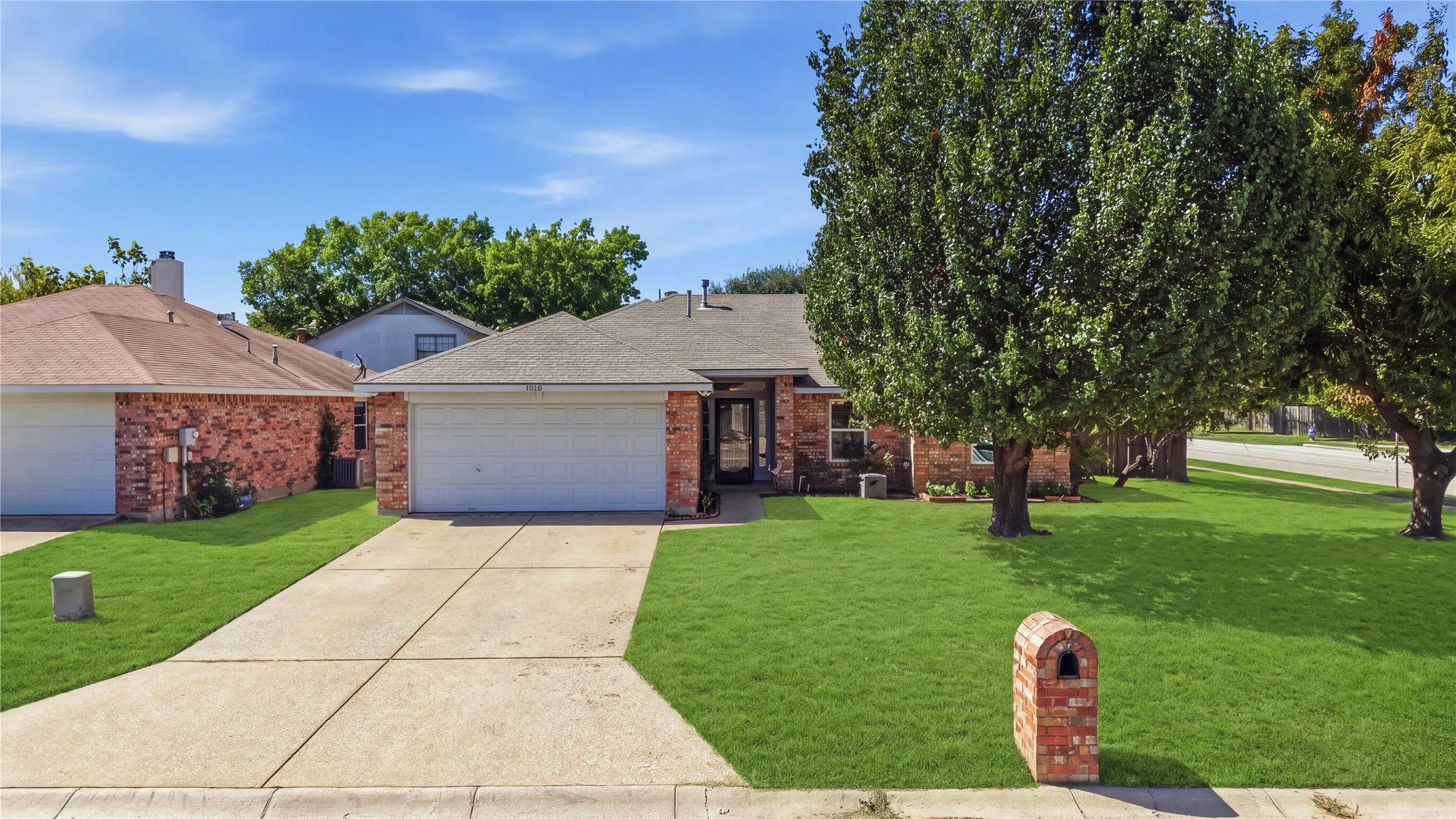 Brick exterior with an attached two-car garage