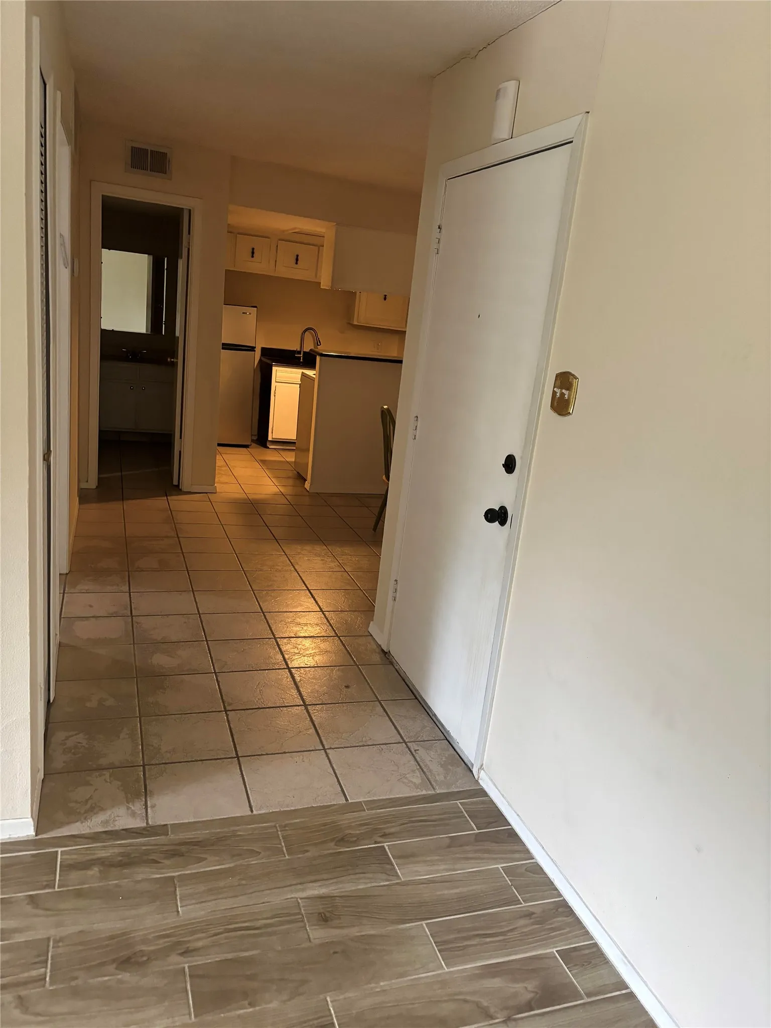 Hall with light tile floors