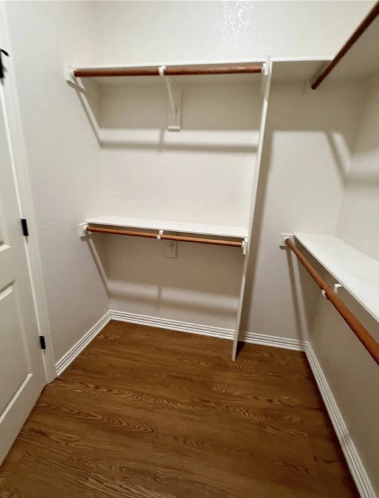 Wood-finish flooring with white baseboards