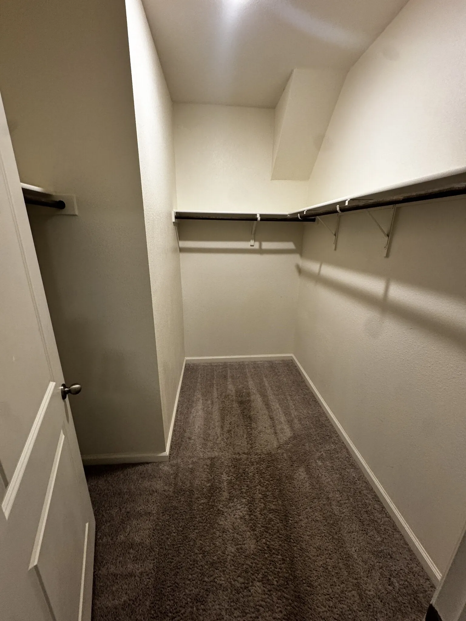 Walk-in closet with integrated shelving and hanging rods