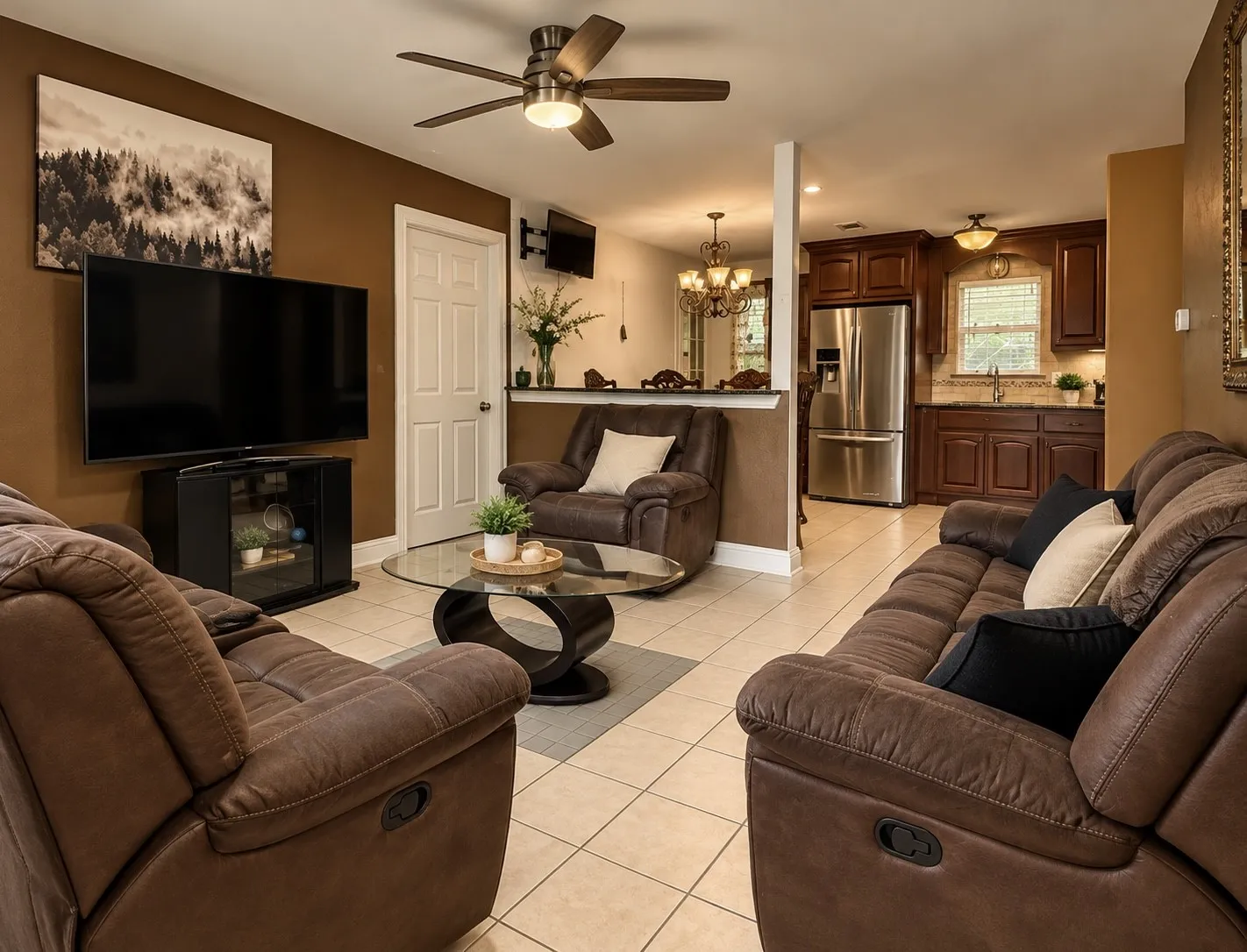 Open-concept living area with tile flooring and a ceiling fan