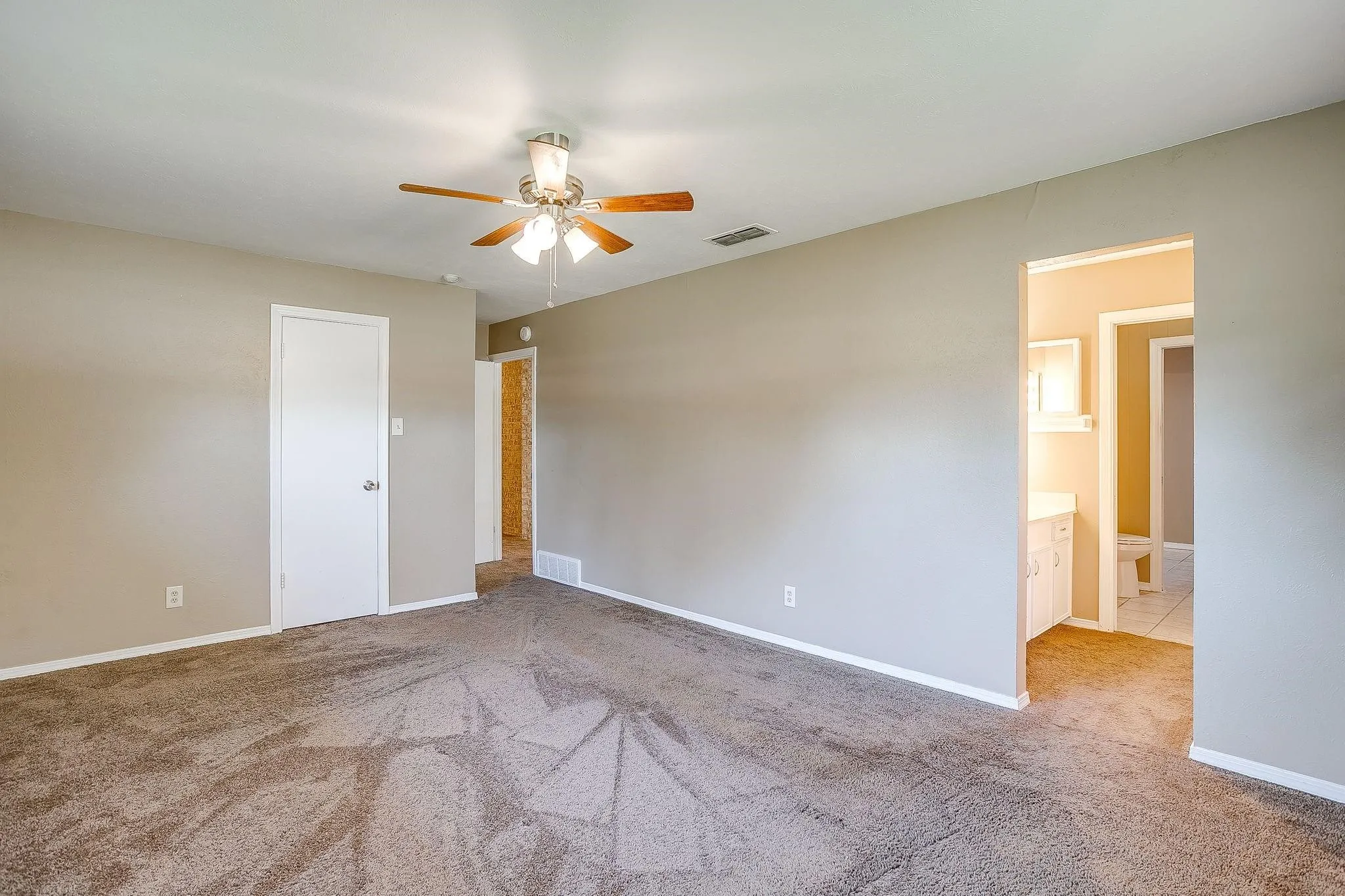 Neutral wall paint and brown carpet flooring