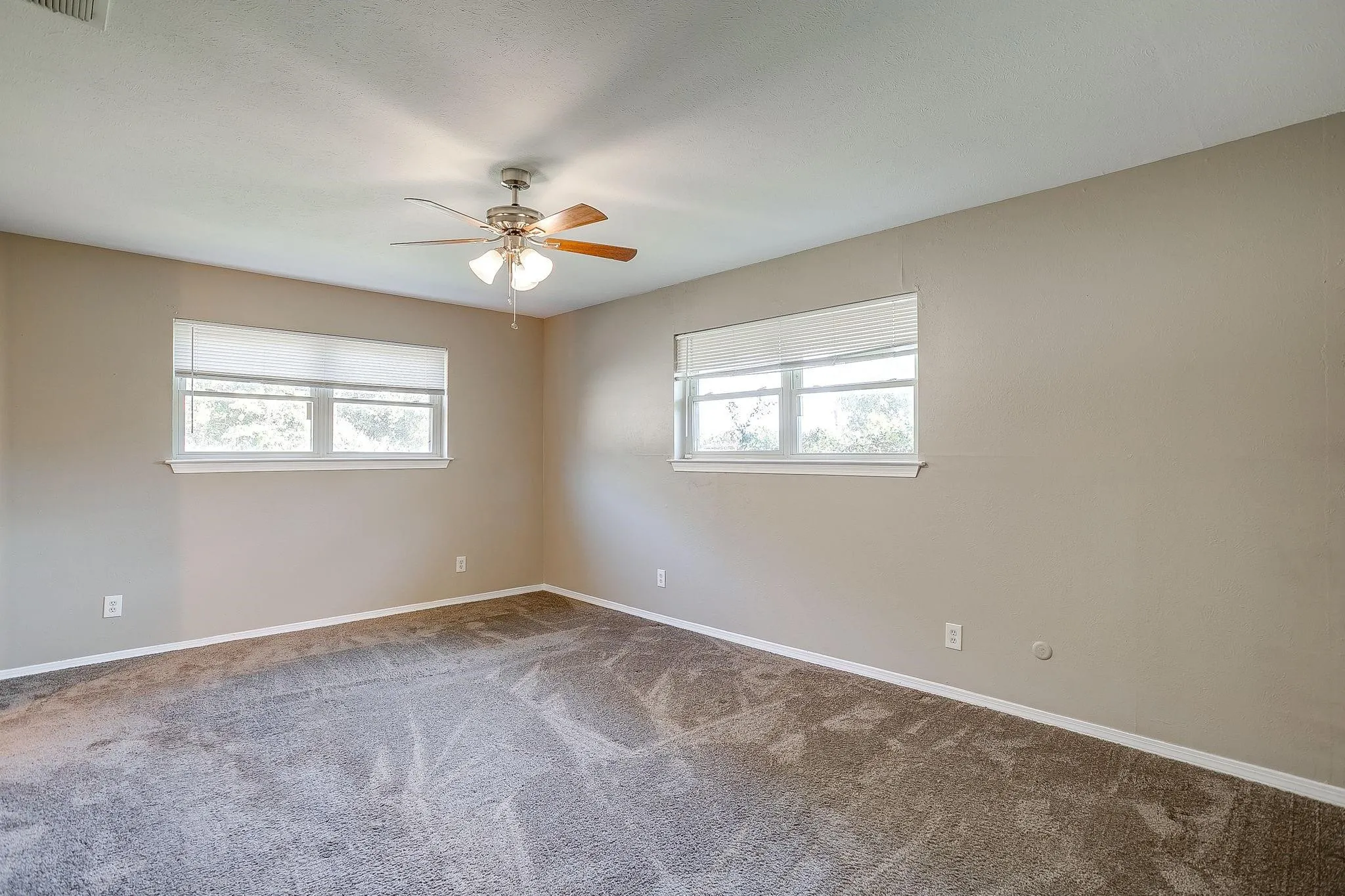 Neutral-toned walls complement plush carpeting