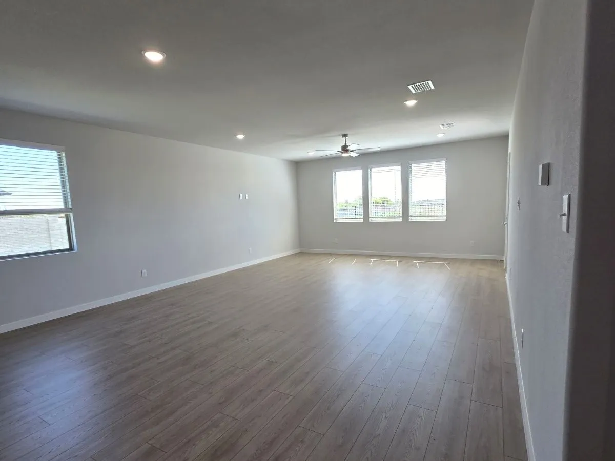 Recessed lighting, wood-finish flooring, ceiling fan, multiple windows with blinds, and light-toned wall finishes