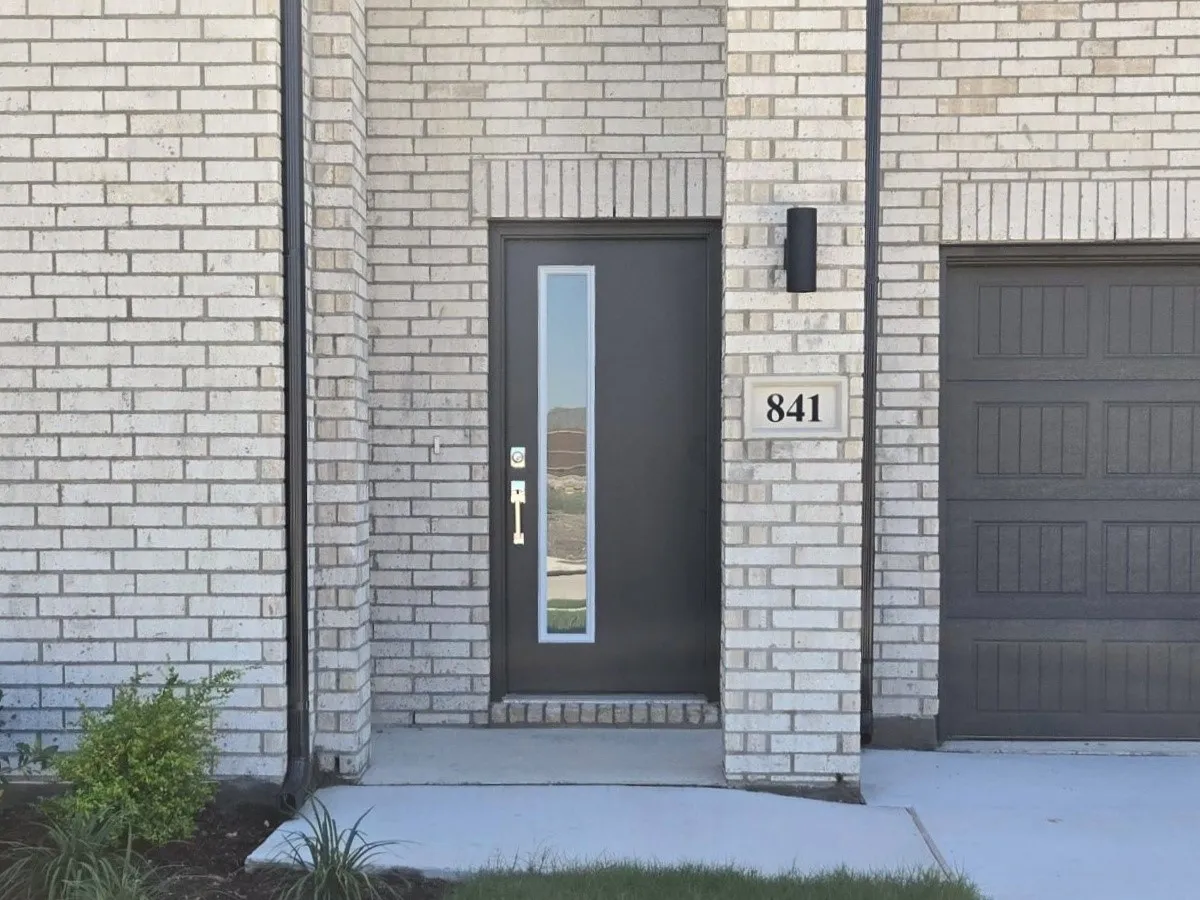 Light-colored brick exterior with dark trim