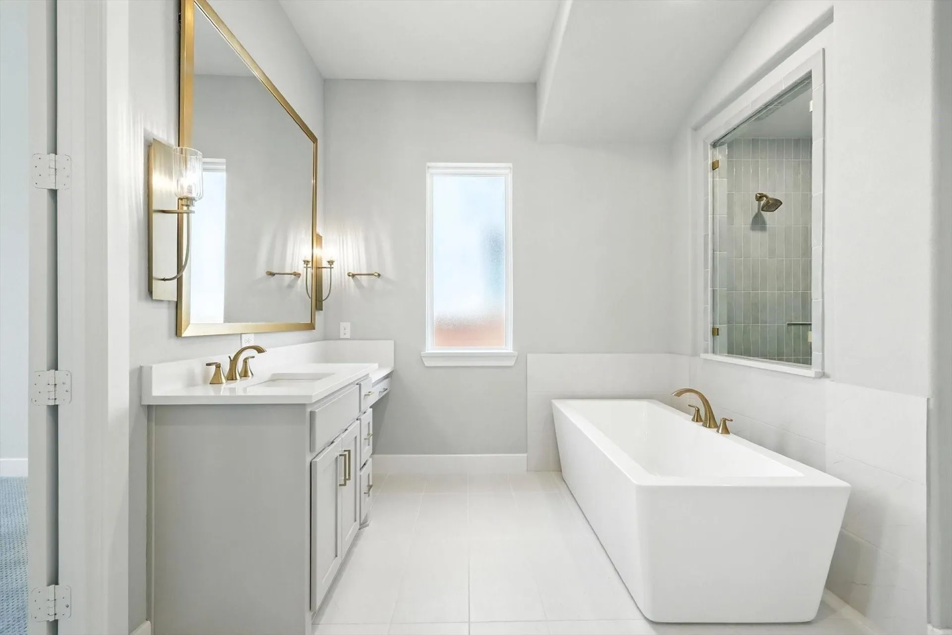 Rectangular freestanding soaking tub with bronze-finish fixtures