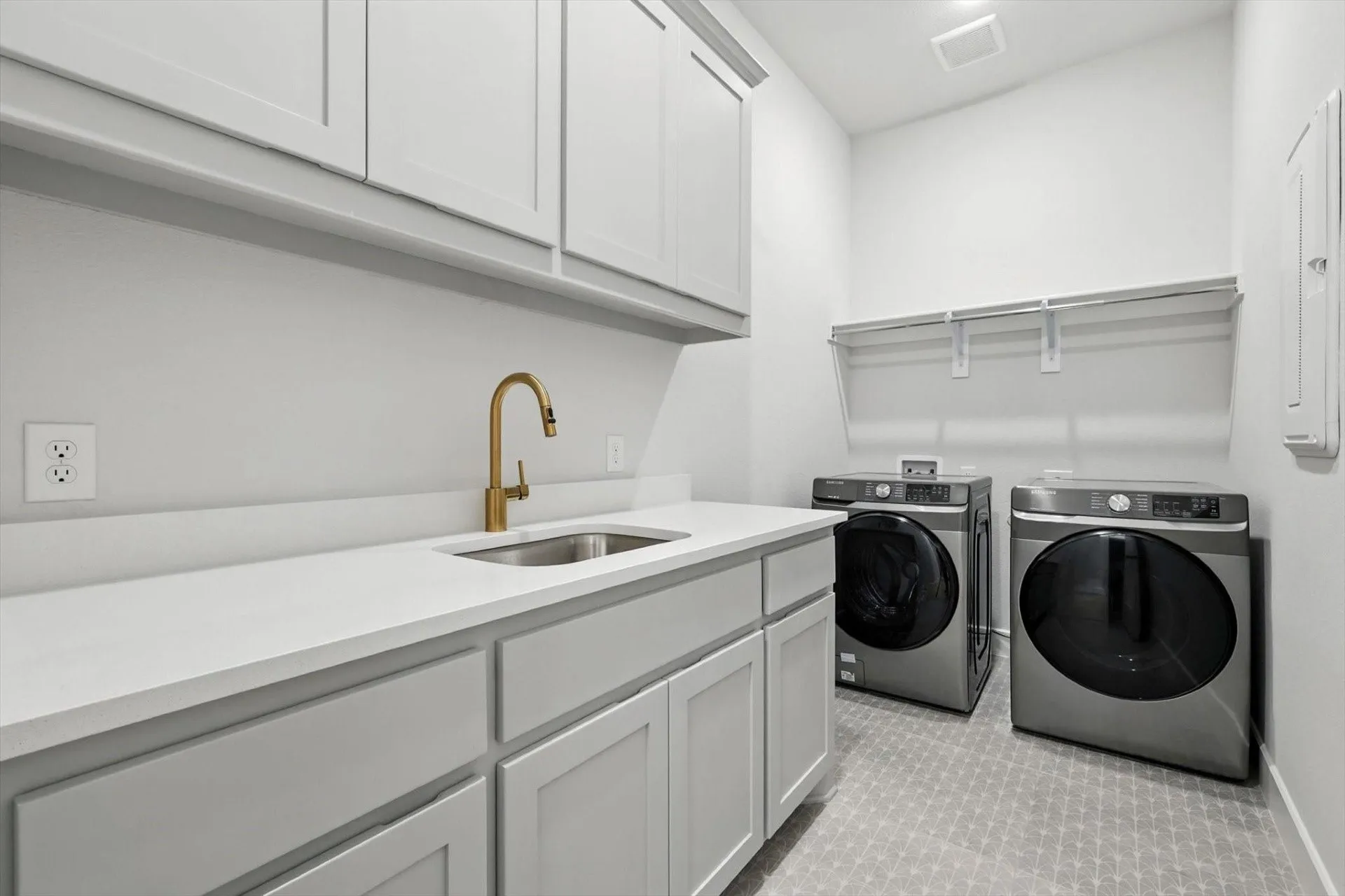 Built-in cabinetry with a white countertop and undermount sink