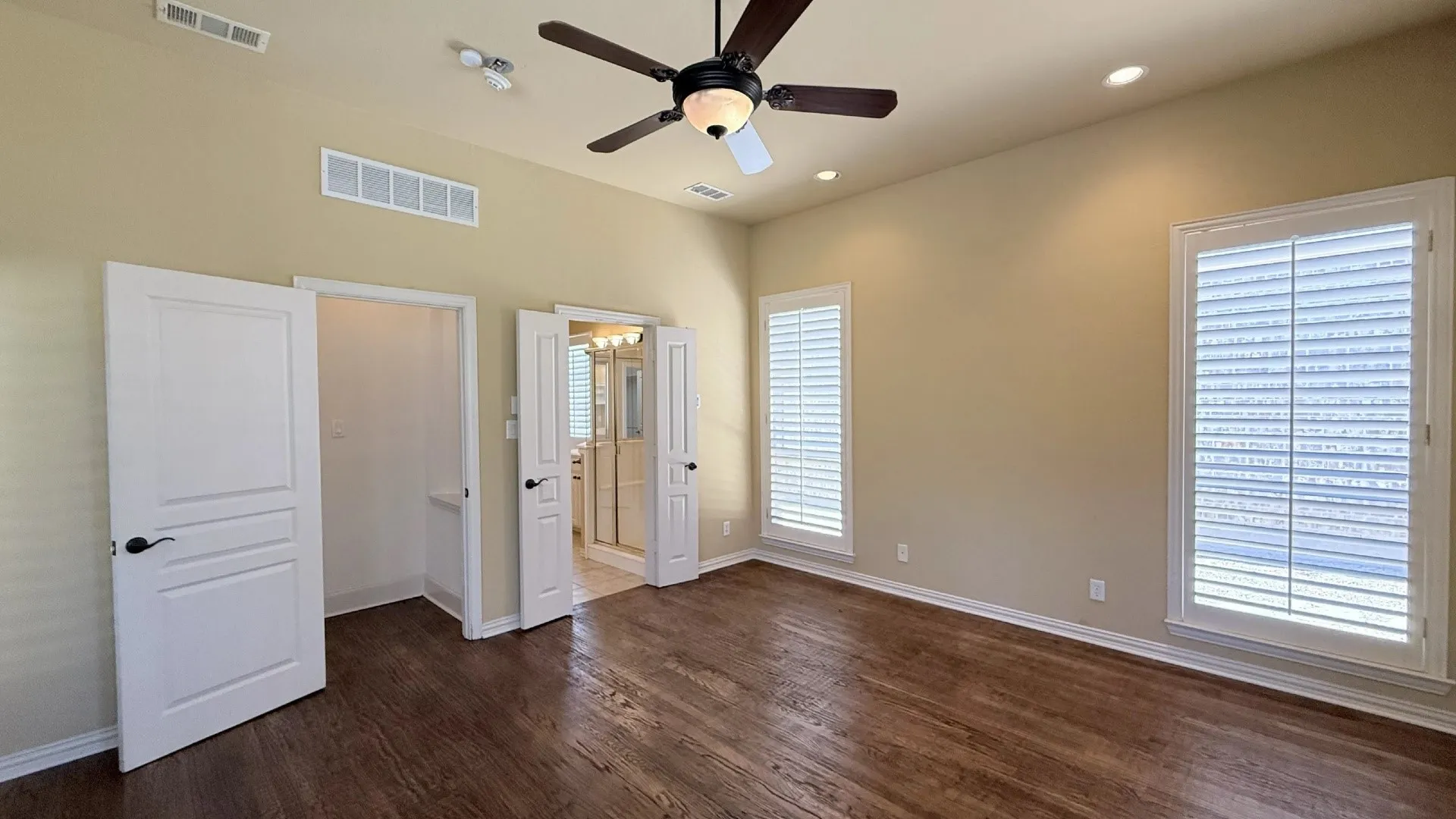 Hardwood-finish flooring, recessed lighting, and a ceiling fan with integrated lighting