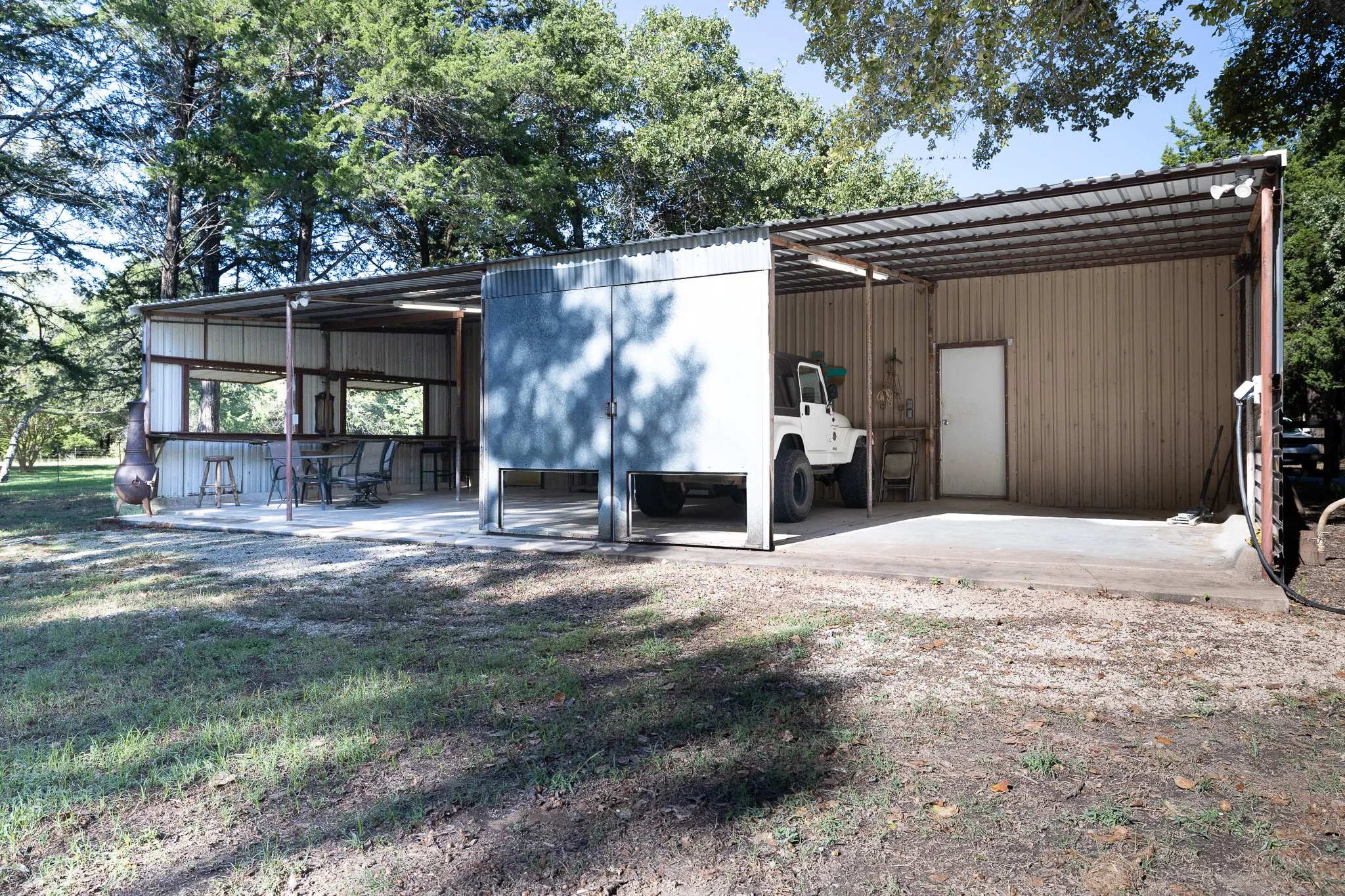 Four car carport at rear of garage