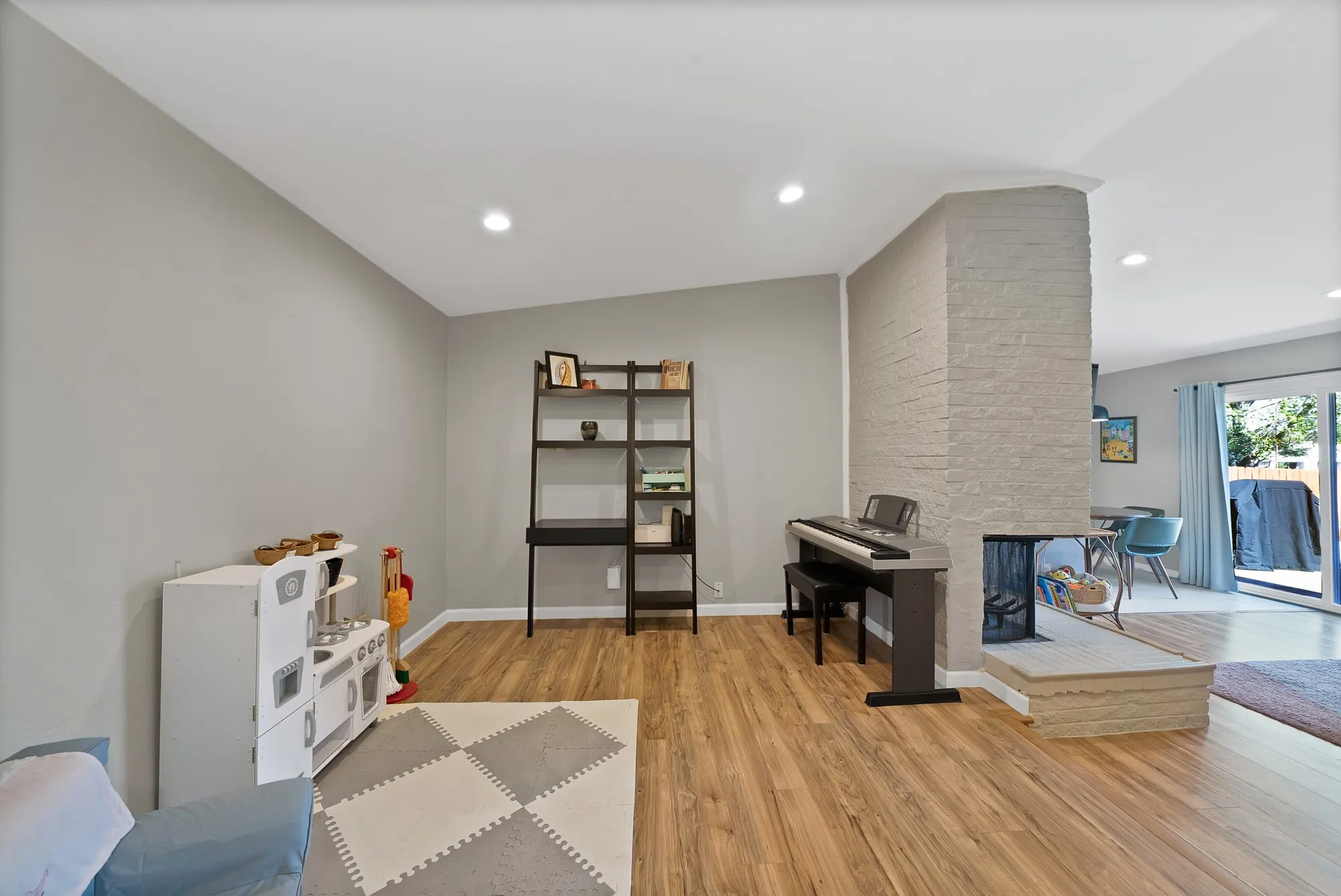 Rec room featuring light wood-style floors, recessed lighting, and a fireplace