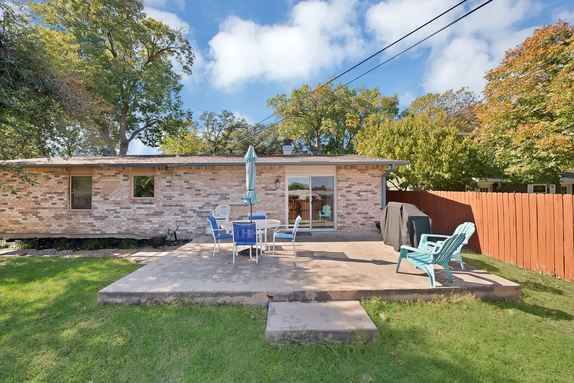 Back of house with a patio and brick siding