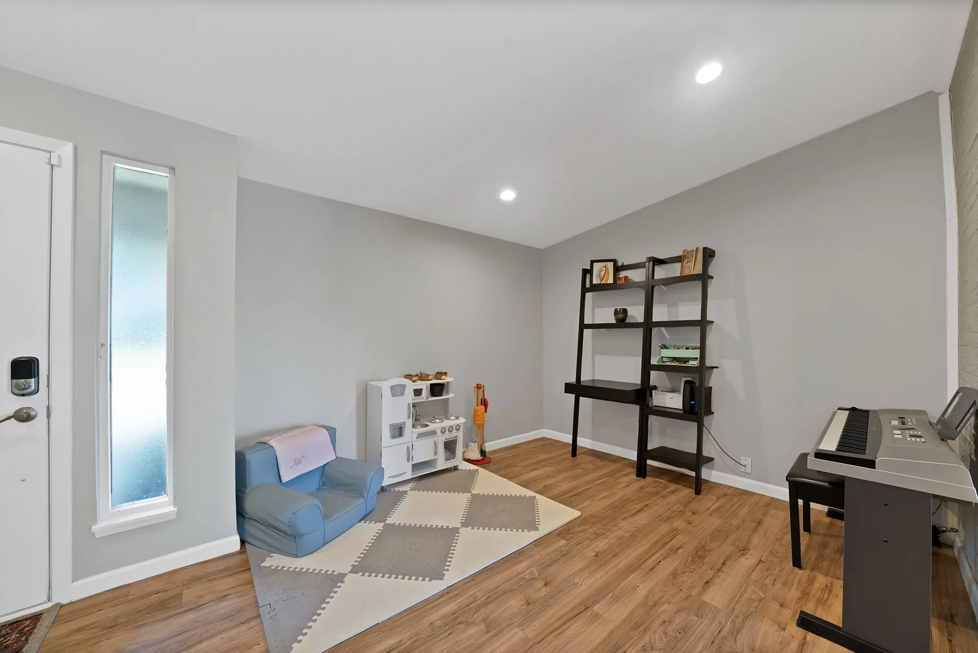 Recreation room with light wood finished floors, recessed lighting, and vaulted ceiling