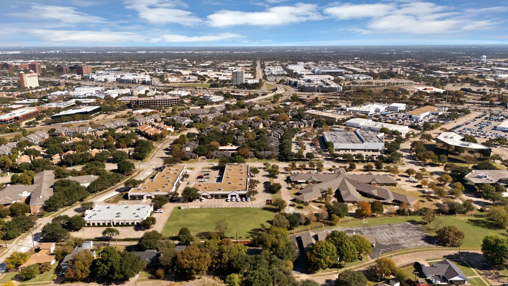 Aerial view of property and surrounding area with nearby urban area