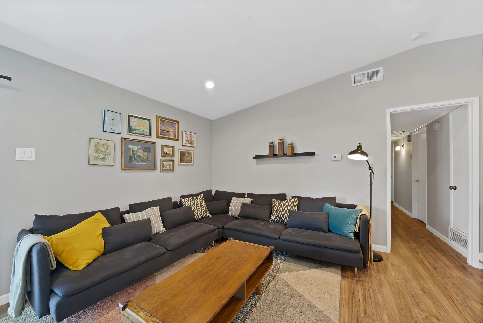 Living area with wood finished floors and recessed lighting