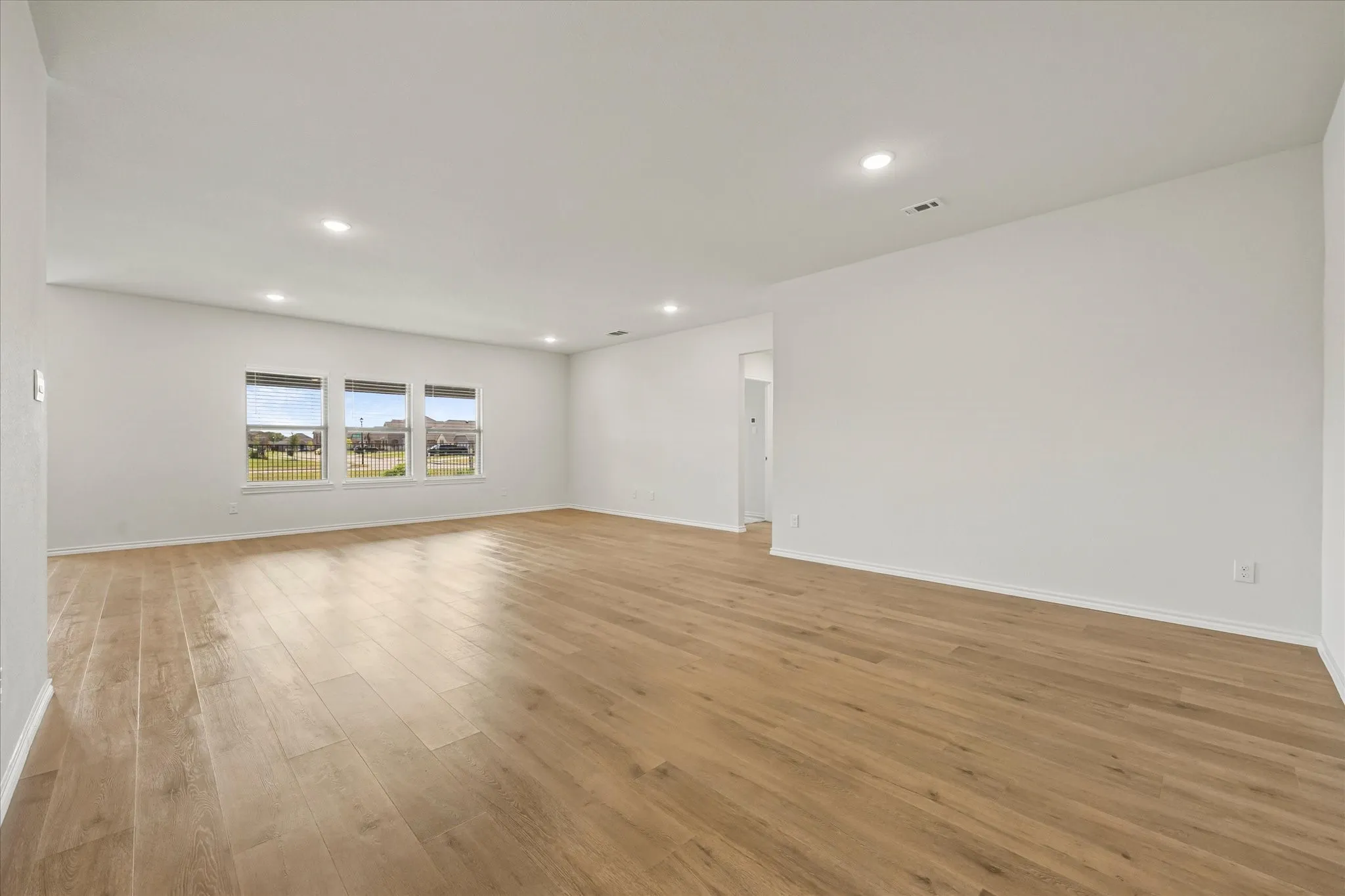 Open floor plan features dining area opening onto family room