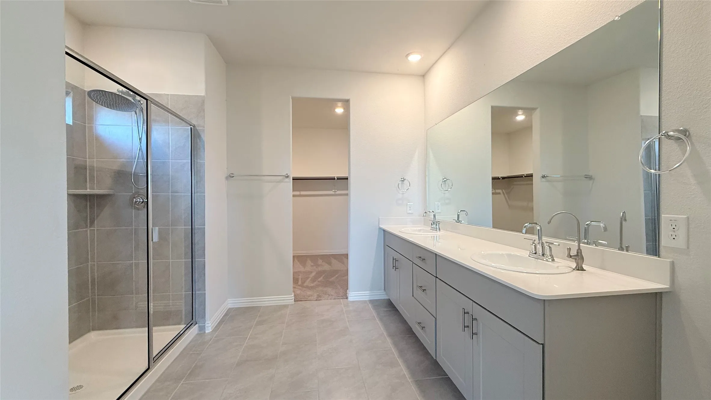 Dual vanity with undermount sinks and light gray cabinetry