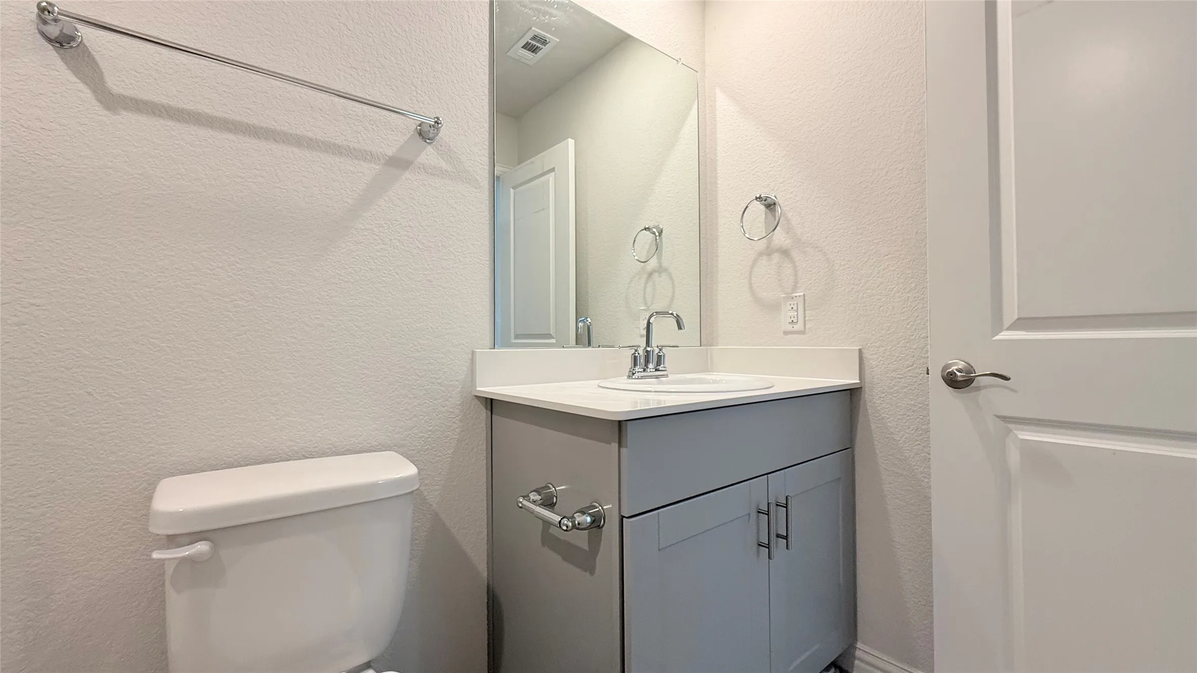 White vanity with undermount sink, chrome faucet, and integrated countertop