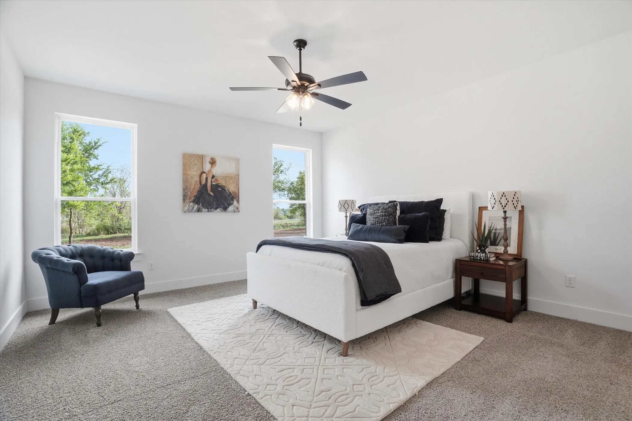 Plush carpeting, multiple windows, and a ceiling fan with integrated lighting
