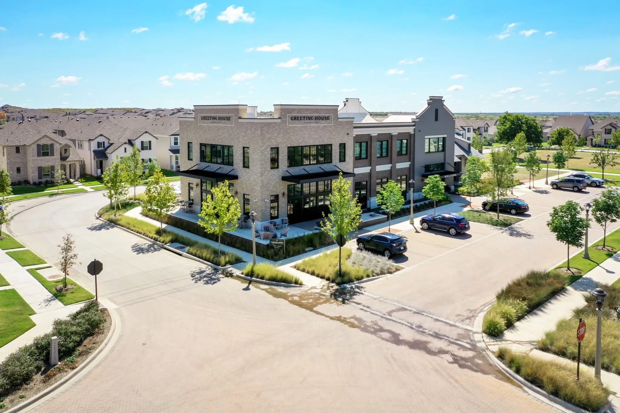 Contemporary commercial building with brick and dark grey facades, multiple large windows, and a covered outdoor patio​​‌​​​​‌​​‌‌​‌‌​​​‌‌​‌​‌​‌​​​‌​​ area