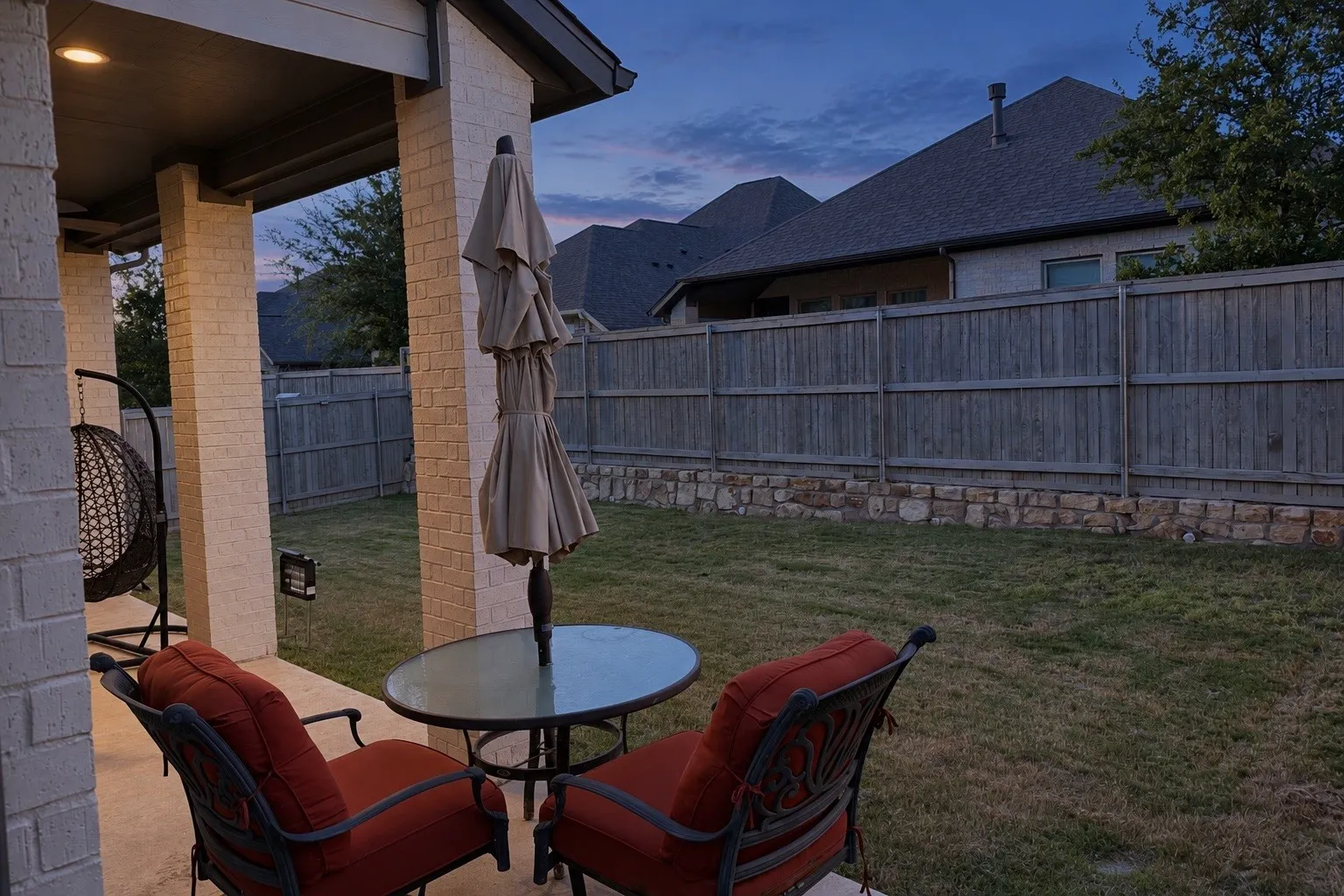 Covered patio with recessed lighting, brick columns, and a concrete surface