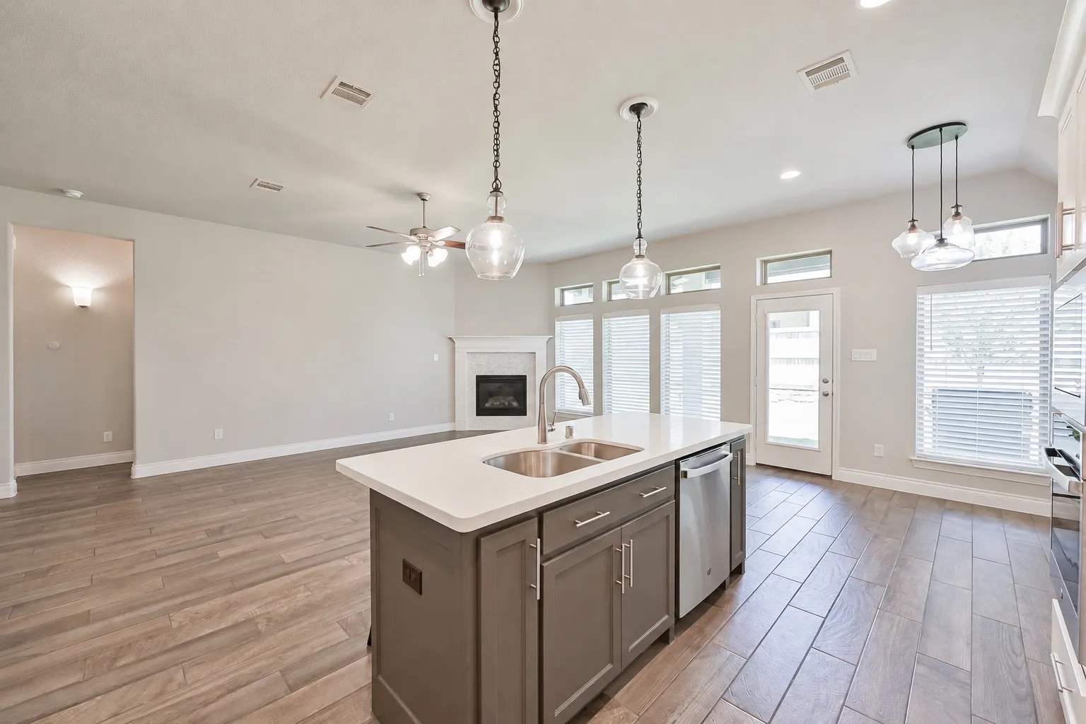 Kitchen island with a double basin sink and a stainless steel dishwasher