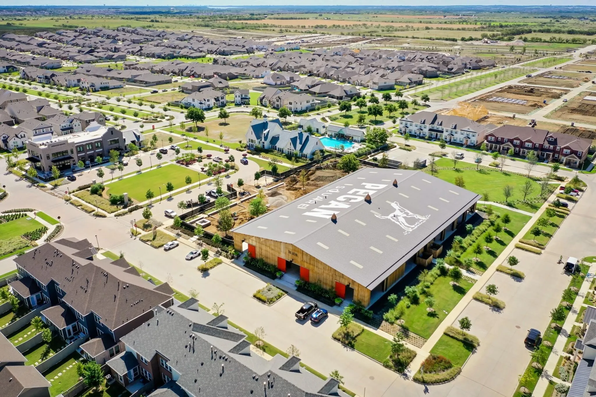 Community green spaces and an in-ground swimming pool are visible