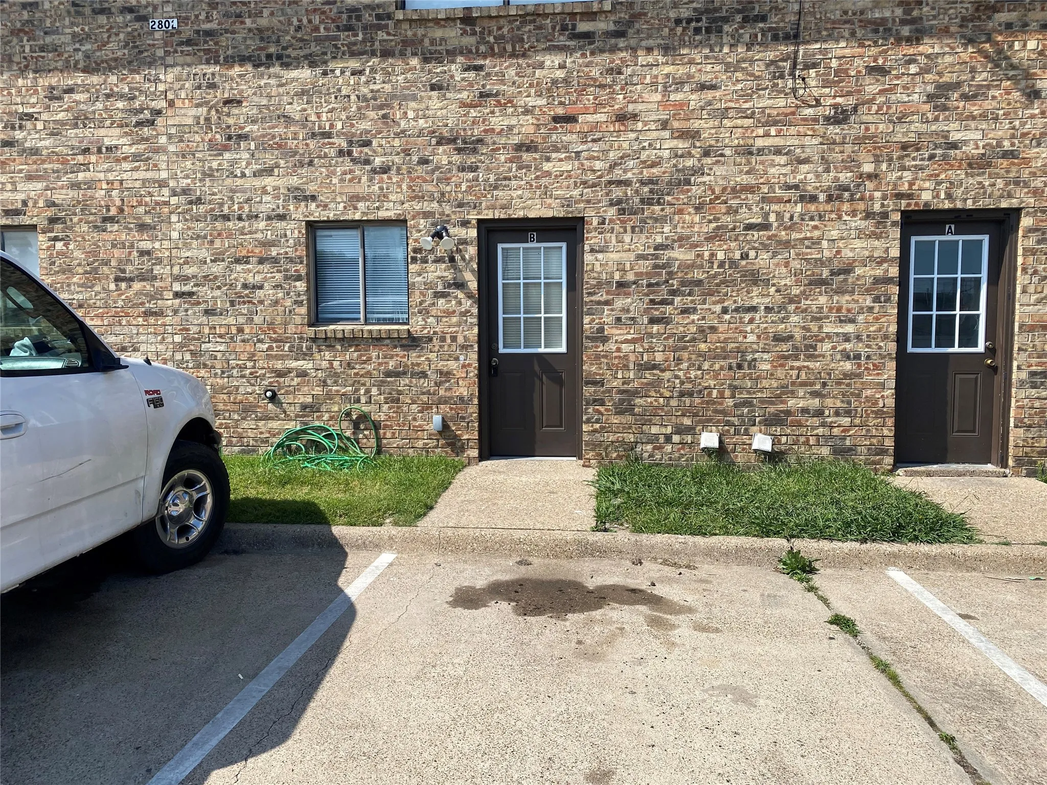 Doorway to property featuring uncovered parking