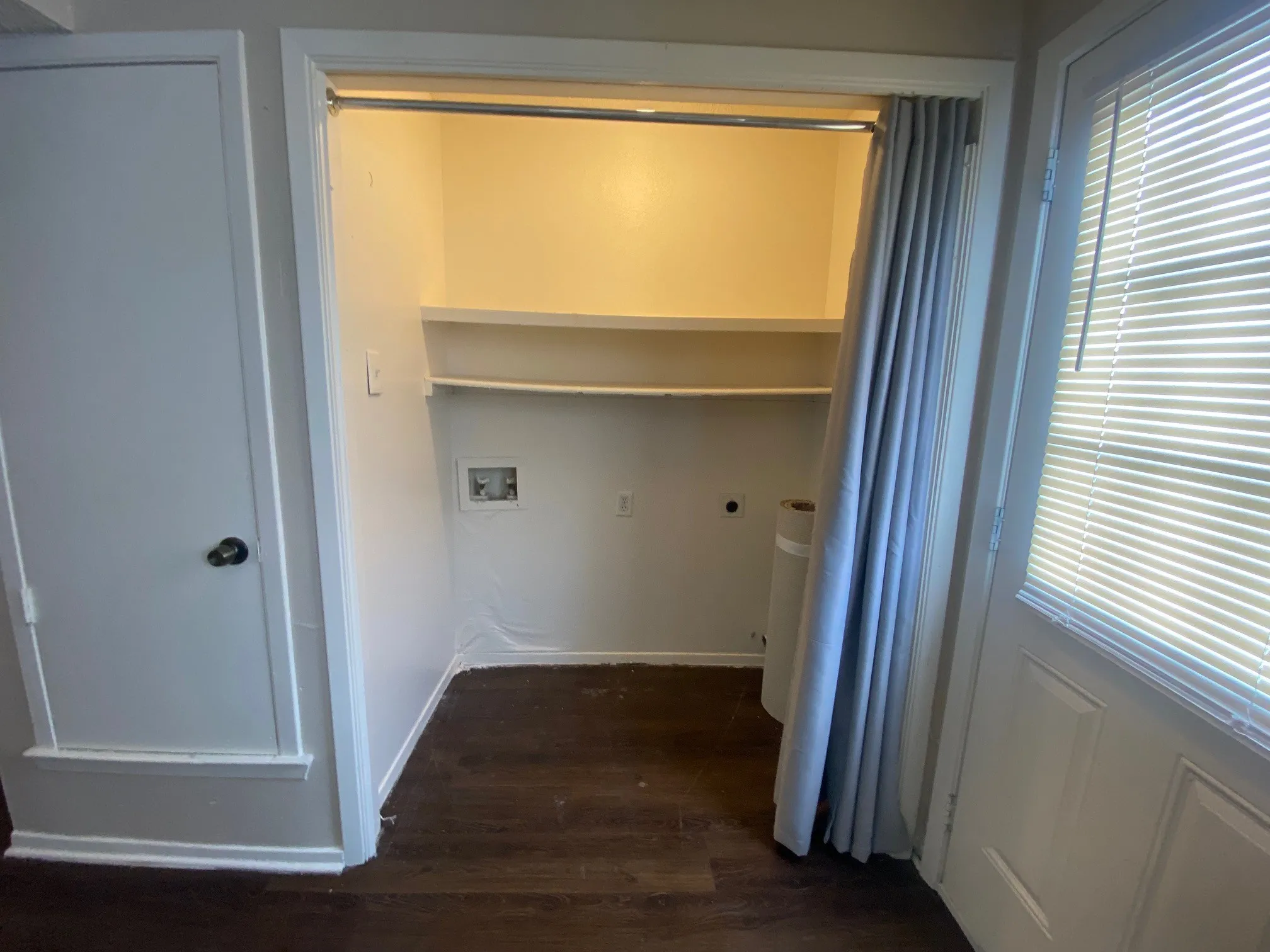 Laundry room featuring wood finished floors, laundry area, plenty of natural light, electric dryer hookup, and washer hookup
