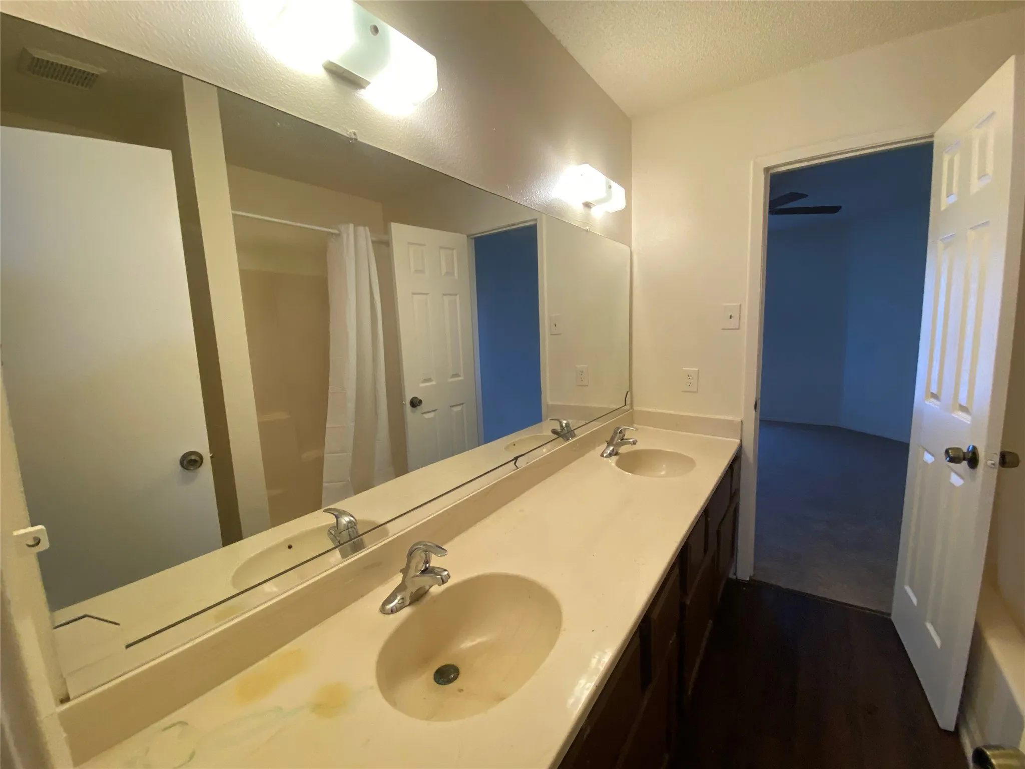 Full bathroom featuring a sink, wood finished floors, and visible vents