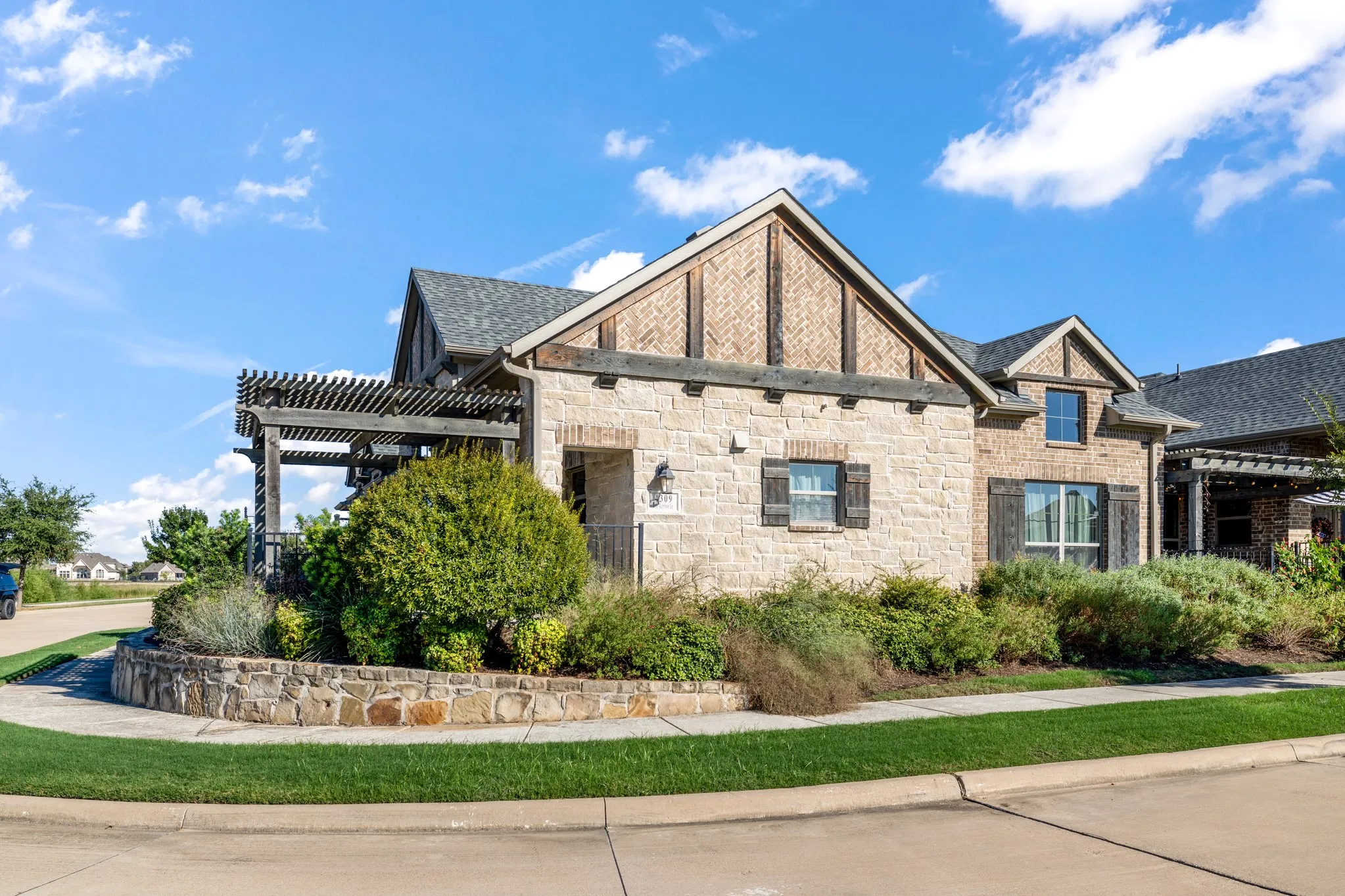 Stone and brick exterior with dark wood shutters