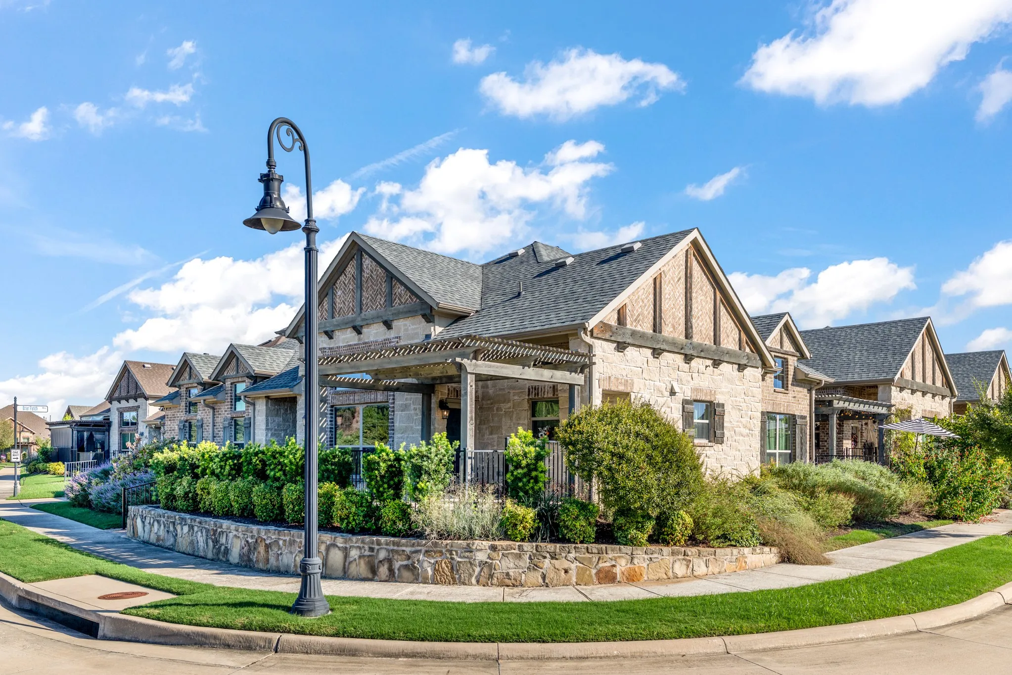 Stone veneer exterior with dark shingle roofing